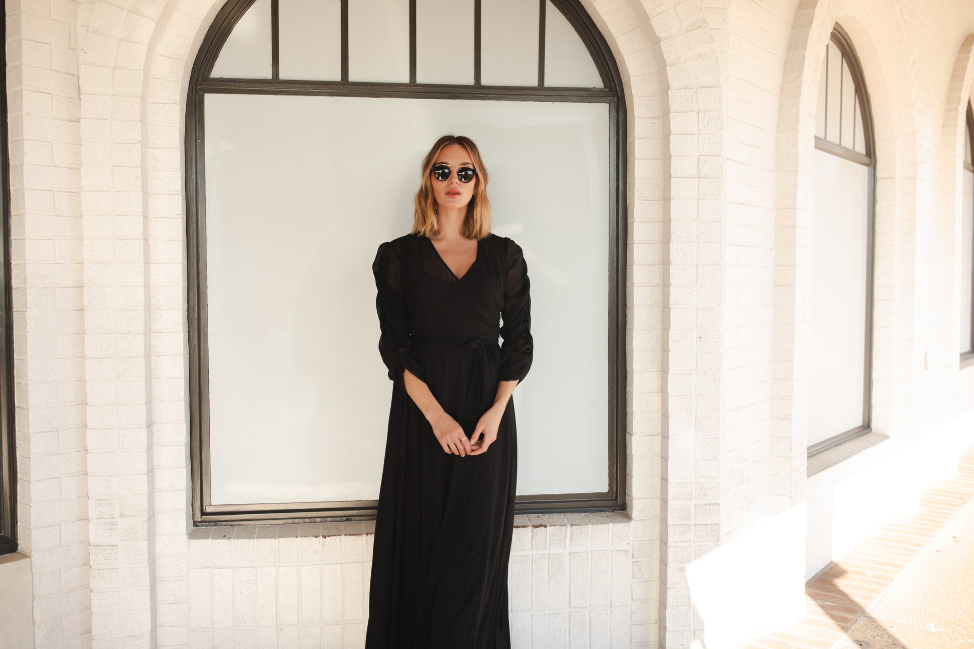 Semi-sheer black maxi dress. The dress features a wrap front, v-neck, three-quarter sleeve with ruching detail, and a matching black slip dress underneath. Classic, vintage inspired black maxi dress with a gothic flair.