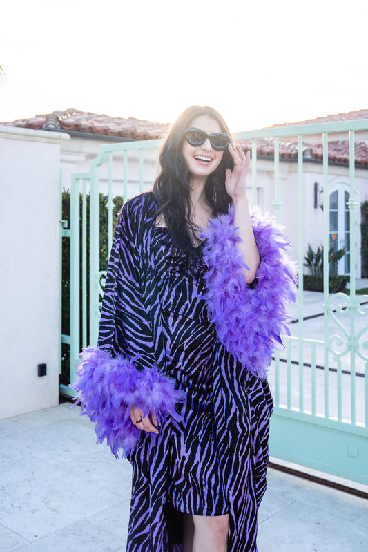 Velvet zebra print overcoat with periwinkle purple. Featuring light purple feathers around sleeve hem, two hook and eye closures at neck and bust. Batwing sleeves with lots of flow and room. Ankle length hem.