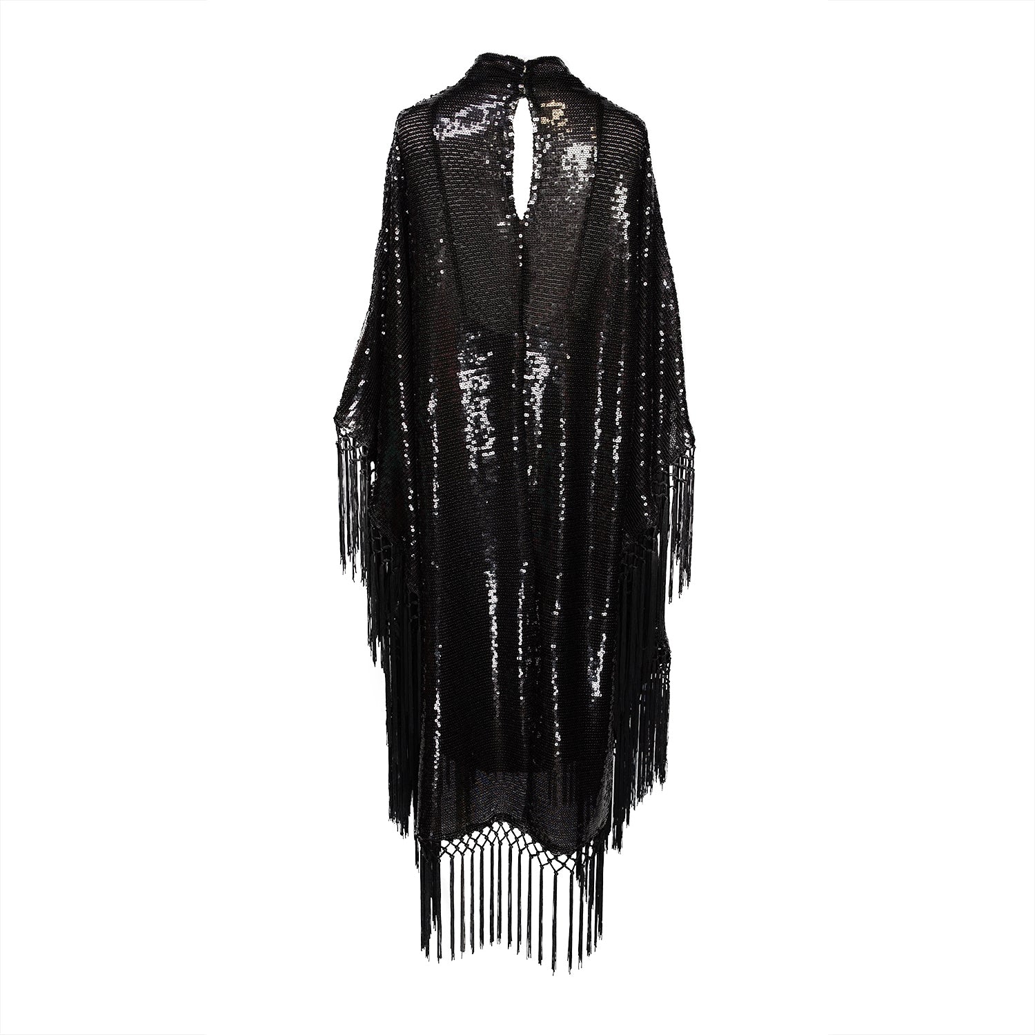 This caftan is a dazzling, full-length garment featuring a shimmering inky black sequin overlay on a mesh fabric. The sequins catch the light, creating a sparkling effect throughout. It has a mock neck collar with a straight, loose fit that drapes elegantly over the body. The edges of the caftan, including the hem and the sides, are embellished with long, black silk fringe that add movement and a playful flair to an elegant and timeless design.