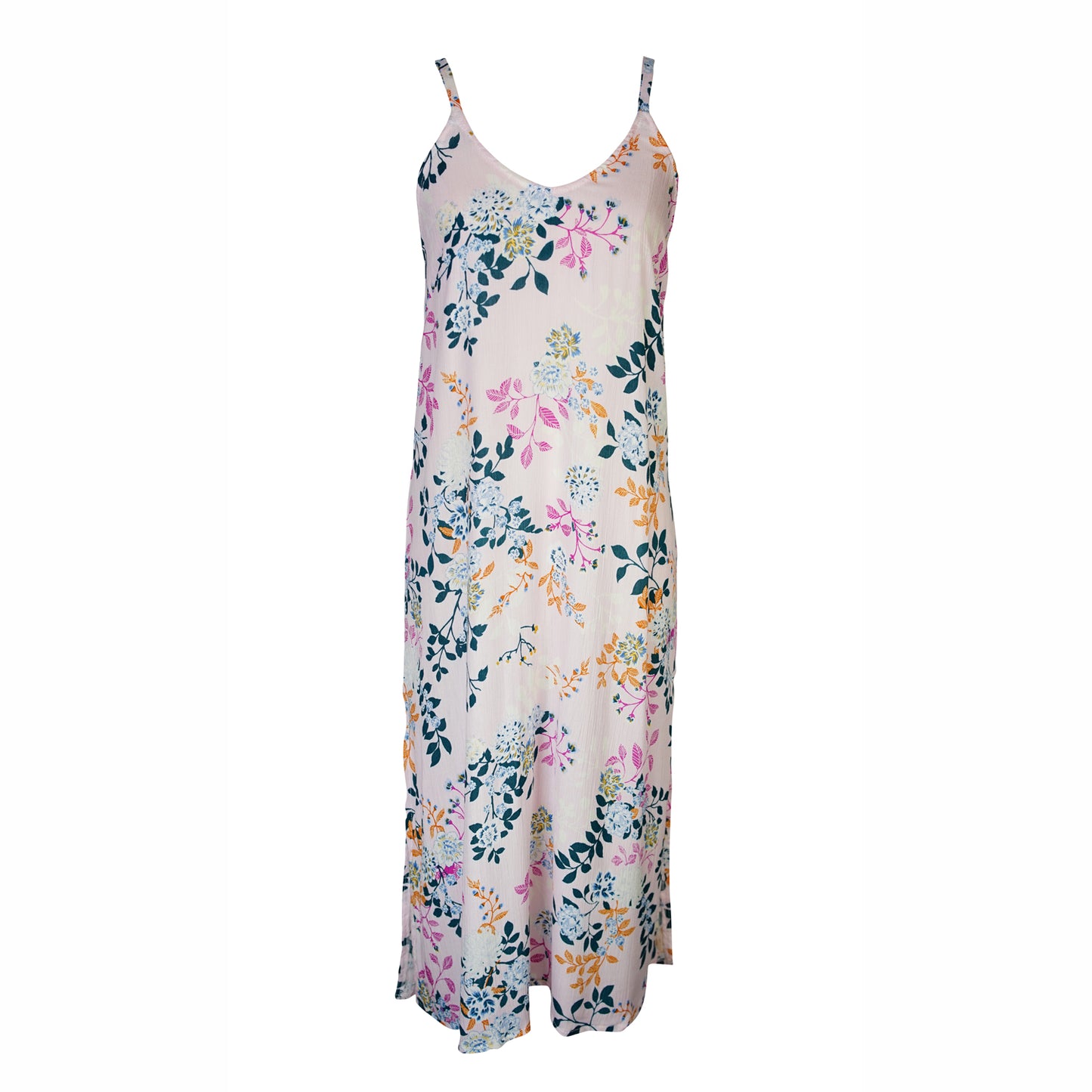 Midi slip dress with a soft blush base color, adorned with a floral pattern featuring shades of blue, pink, yellow, and green. The floral design is distributed evenly throughout, giving the dress a garden-like appearance. It features slender straps with a straight silhouette and relaxed fix, allowing for a beautiful drape and flowy movement. It's designed for a light, airy feel, suitable for warm weather or layered for cooler days.