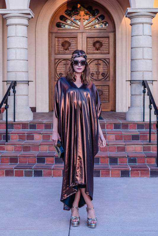 This copper caftan offers a sleek and shimmering look that exudes boldness and luxury made from a generous amount of metallic coated poly/spandex jersey.