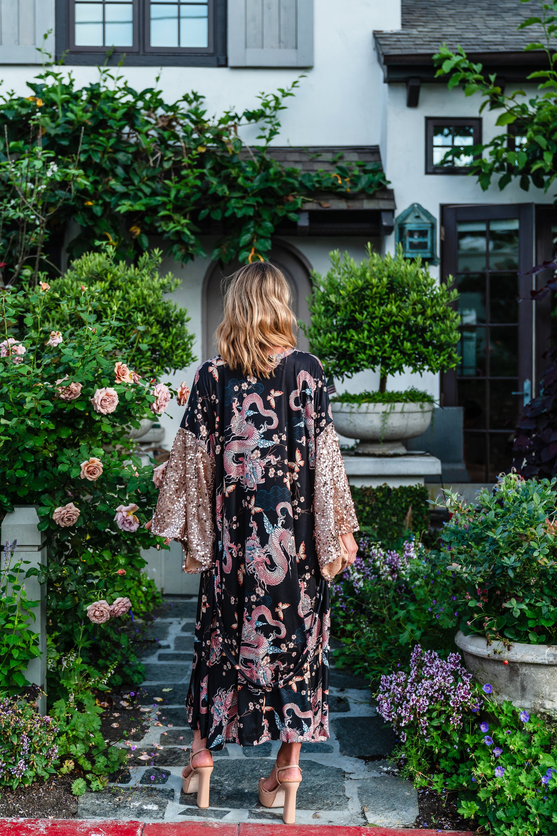 This Kimono is crafted from soft jersey, it features striking dragon print and sequin kimono sleeves.