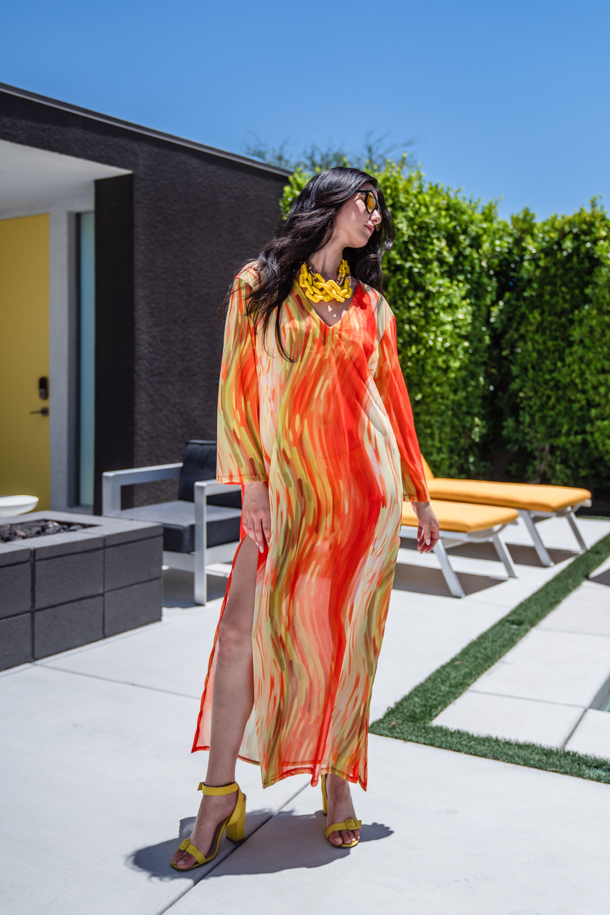 Our Citron Split Hem Caftan With Sleeves! With has vibrant citron orange, bright lime, and vivid yellow colors. This long tunic with high side slits can be a beach cover up