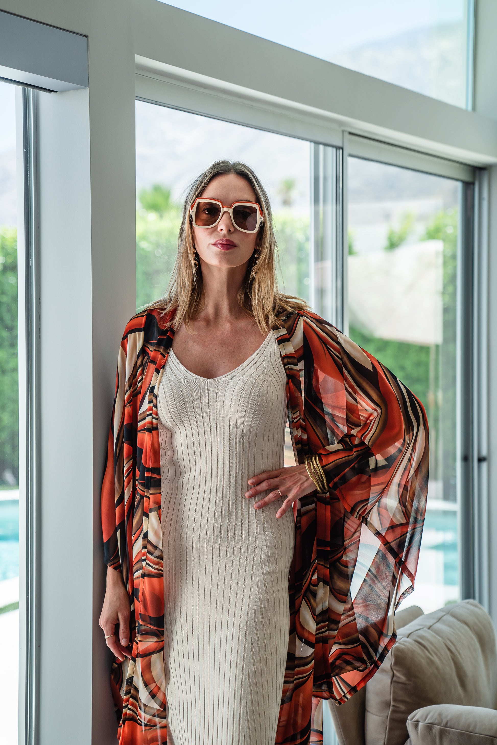 Inspired by the River Styx, the Styx Kimono is a fiery and versatile addition to your wardrobe. Made from chiffon, its abstract geometric design in shades of orange, red, and brown adds a touch of elegance to any outfit.