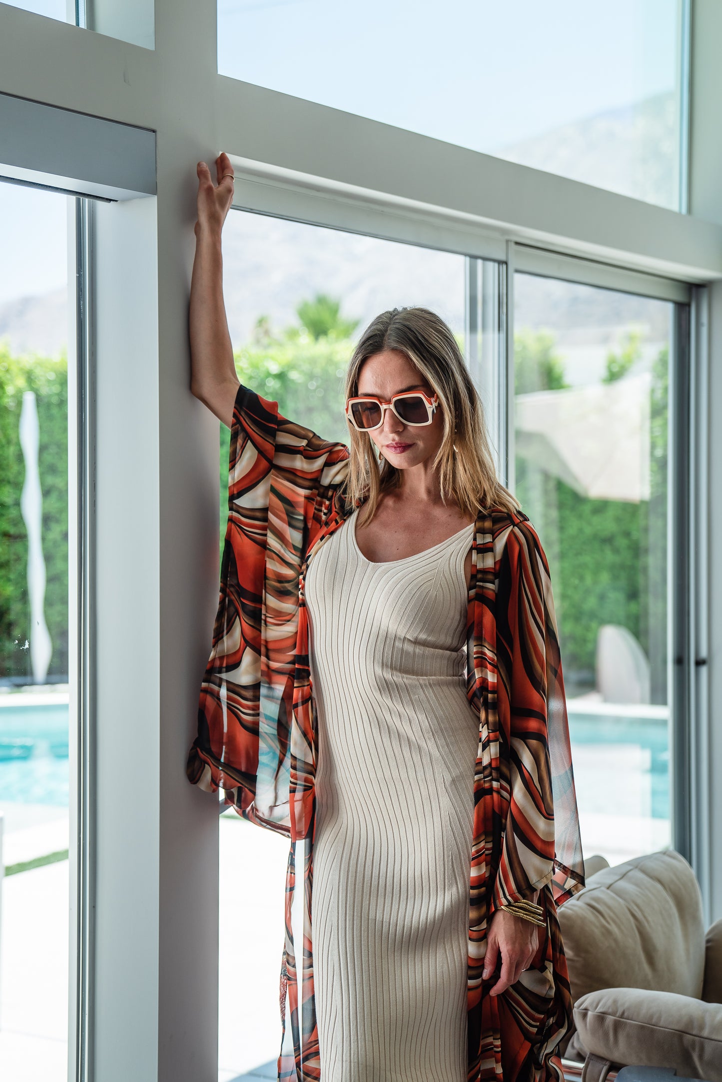 Inspired by the River Styx, the Styx Kimono is a fiery and versatile addition to your wardrobe. Made from chiffon, its abstract geometric design in shades of orange, red, and brown adds a touch of elegance to any outfit.