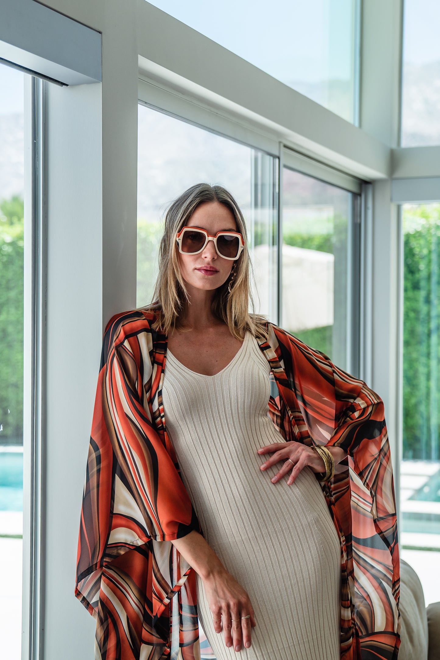 Inspired by the River Styx, the Styx Kimono is a fiery and versatile addition to your wardrobe. Made from chiffon, its abstract geometric design in shades of orange, red, and brown adds a touch of elegance to any outfit.