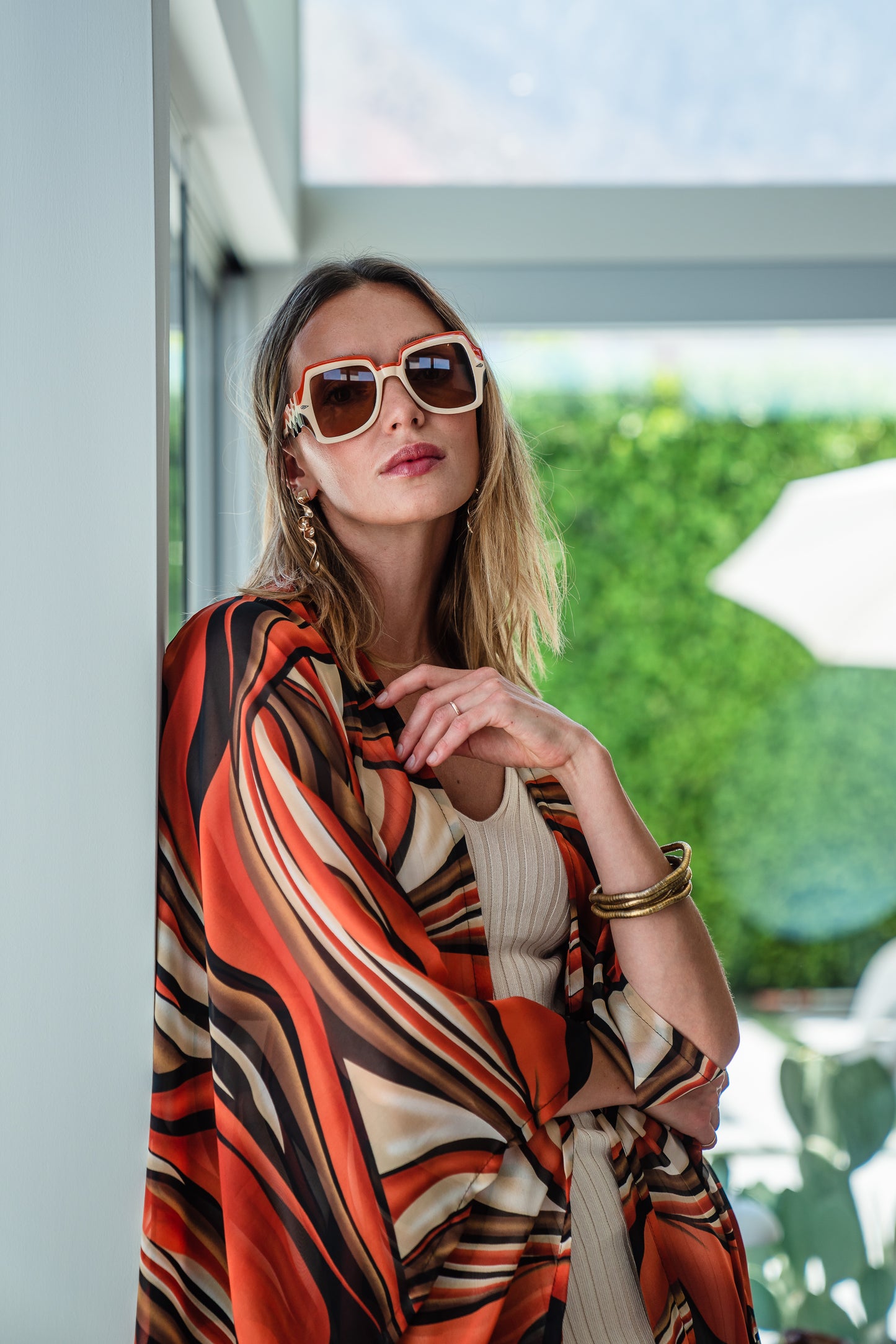 Inspired by the River Styx, the Styx Kimono is a fiery and versatile addition to your wardrobe. Made from chiffon, its abstract geometric design in shades of orange, red, and brown adds a touch of elegance to any outfit.