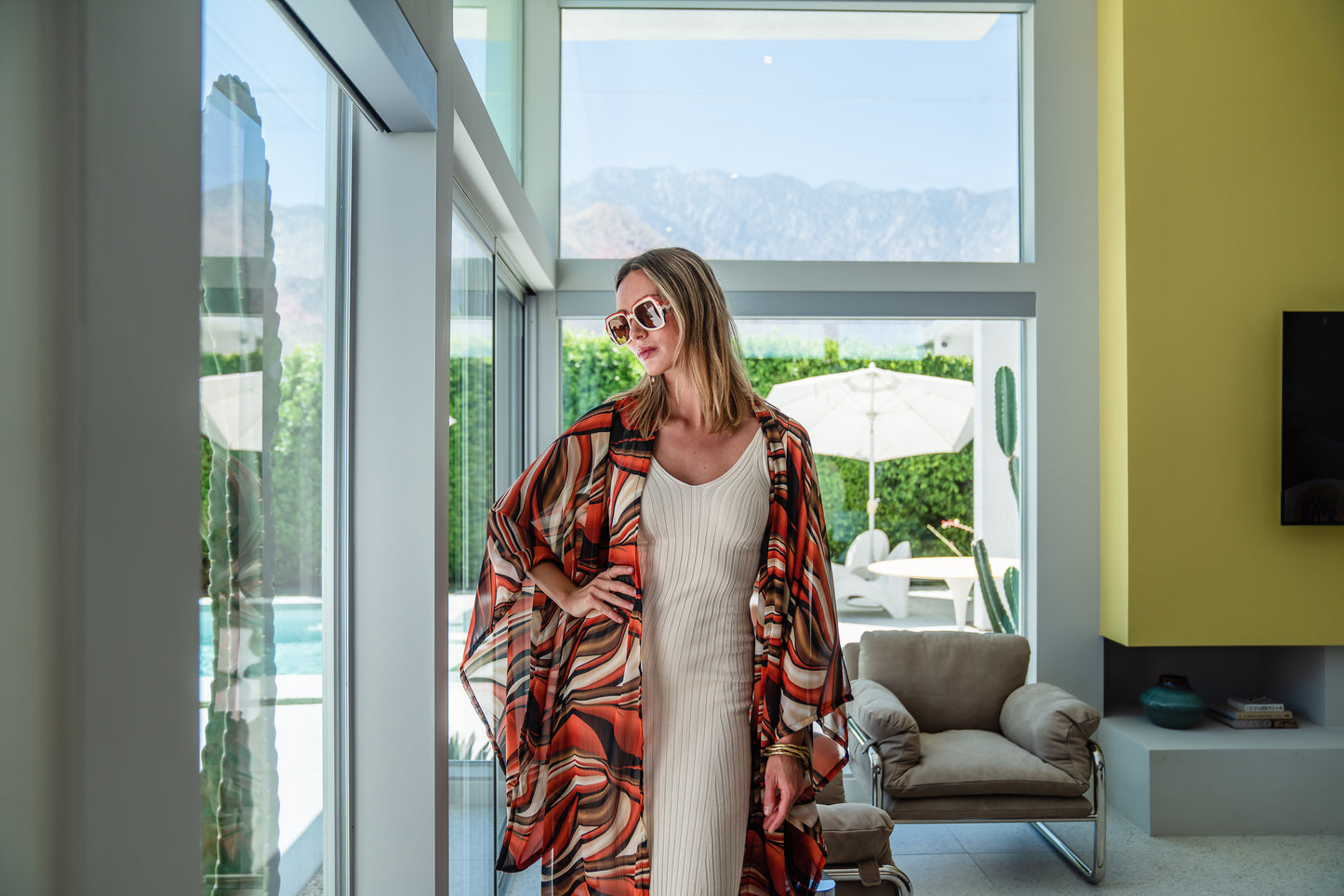 Inspired by the River Styx, the Styx Kimono is a fiery and versatile addition to your wardrobe. Made from chiffon, its abstract geometric design in shades of orange, red, and brown adds a touch of elegance to any outfit.