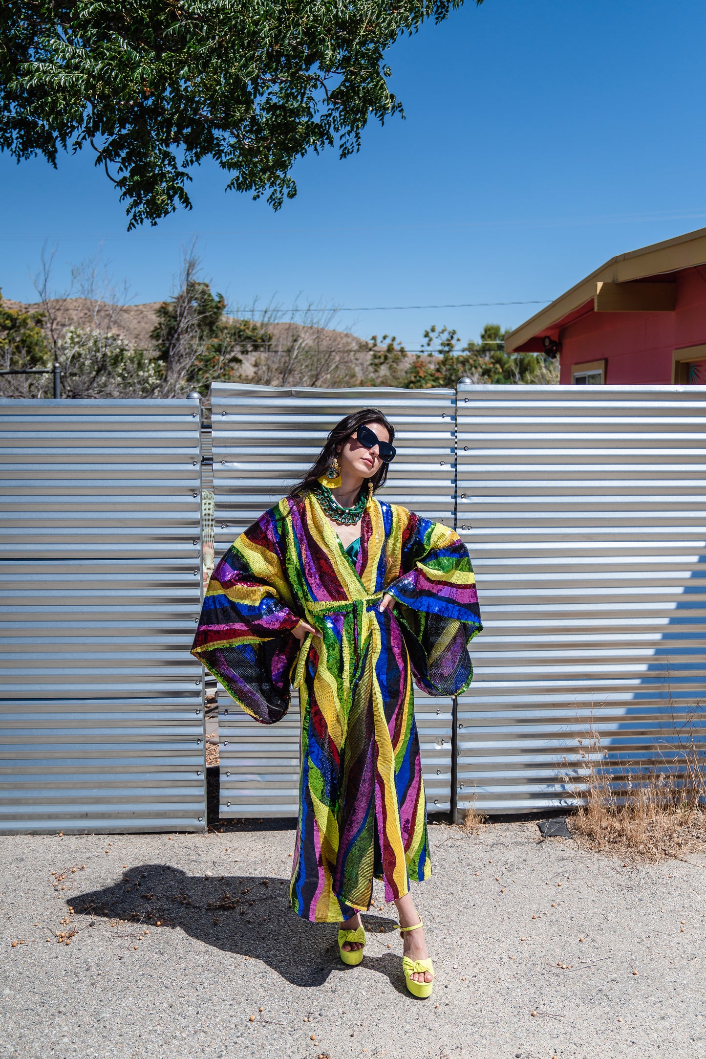 Introducing the Rainbow Road Kimono. This elegant piece boasts an iridescent sequin in a wavy vertical line design with art nouveau inspiration. Featuring an ankle length hem, and drapy rectangular sleeves of a traditional kimono design, and long removeable belt, this kimono can be worn as a stunning dress or layered over your favorite outfits.
