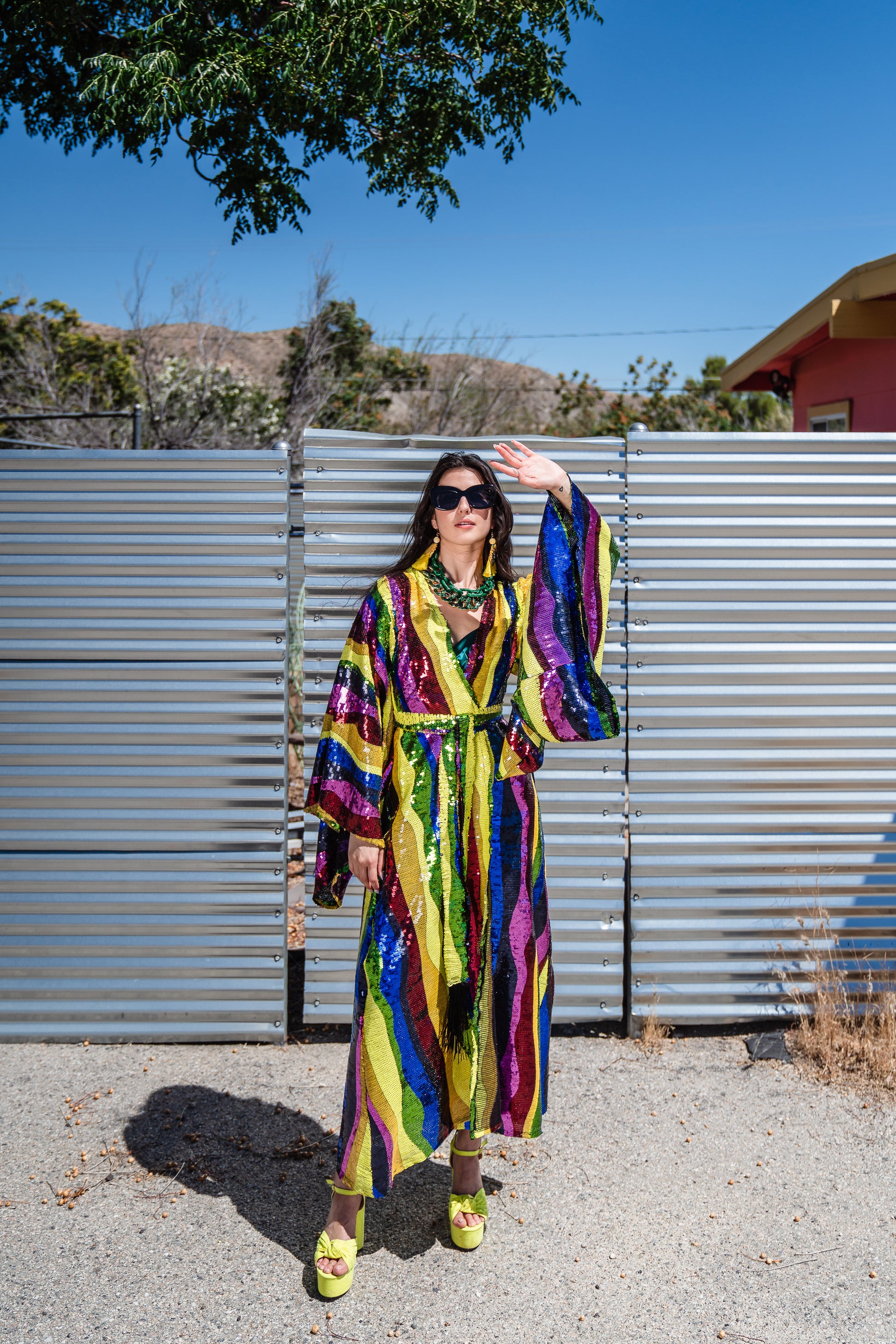 Introducing the Rainbow Road Kimono. This elegant piece boasts an iridescent sequin in a wavy vertical line design with art nouveau inspiration. Featuring an ankle length hem, and drapy rectangular sleeves of a traditional kimono design, and long removeable belt, this kimono can be worn as a stunning dress or layered over your favorite outfits.
