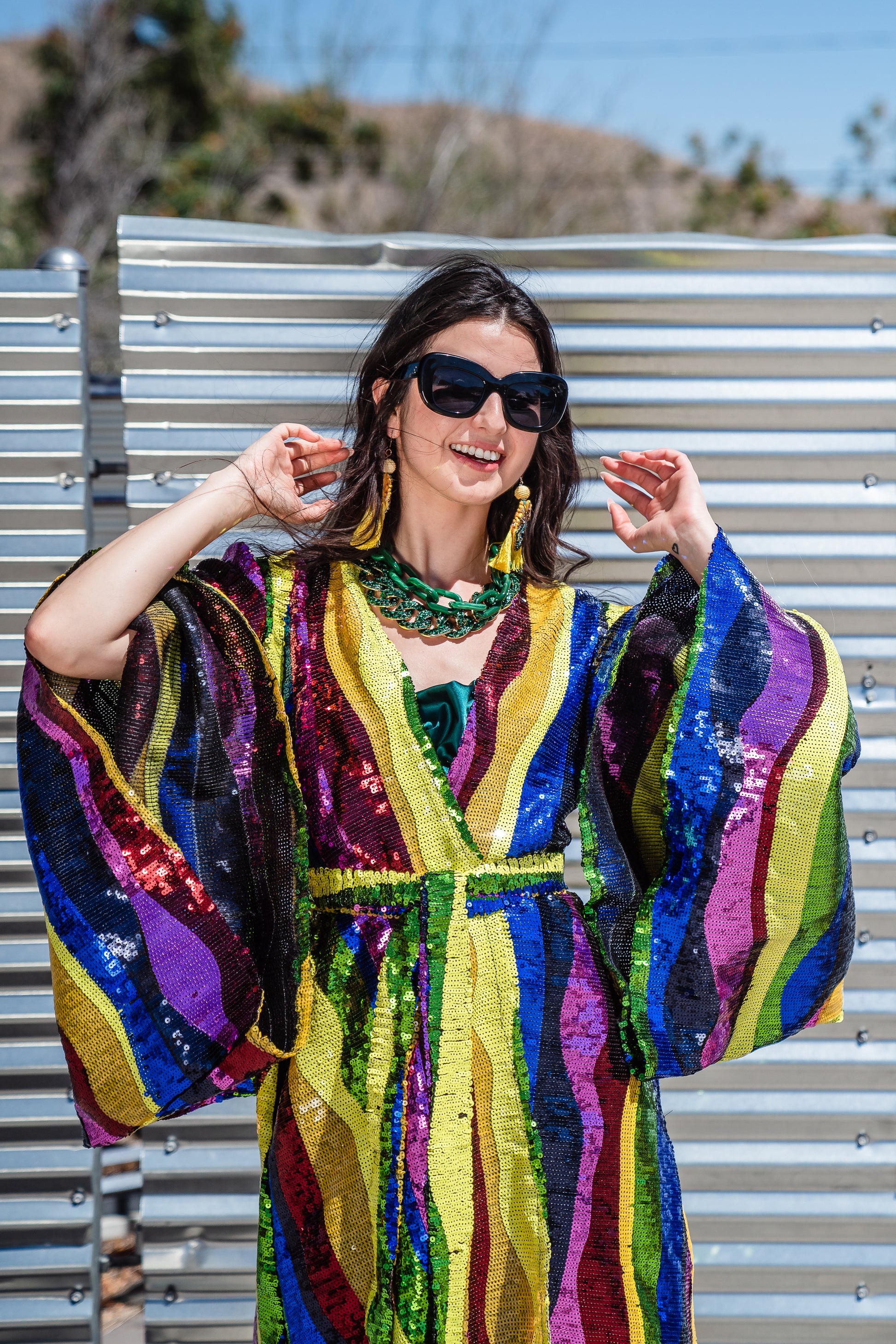 Introducing the Rainbow Road Kimono. This elegant piece boasts an iridescent sequin in a wavy vertical line design with art nouveau inspiration. Featuring an ankle length hem, and drapy rectangular sleeves of a traditional kimono design, and long removeable belt, this kimono can be worn as a stunning dress or layered over your favorite outfits.
