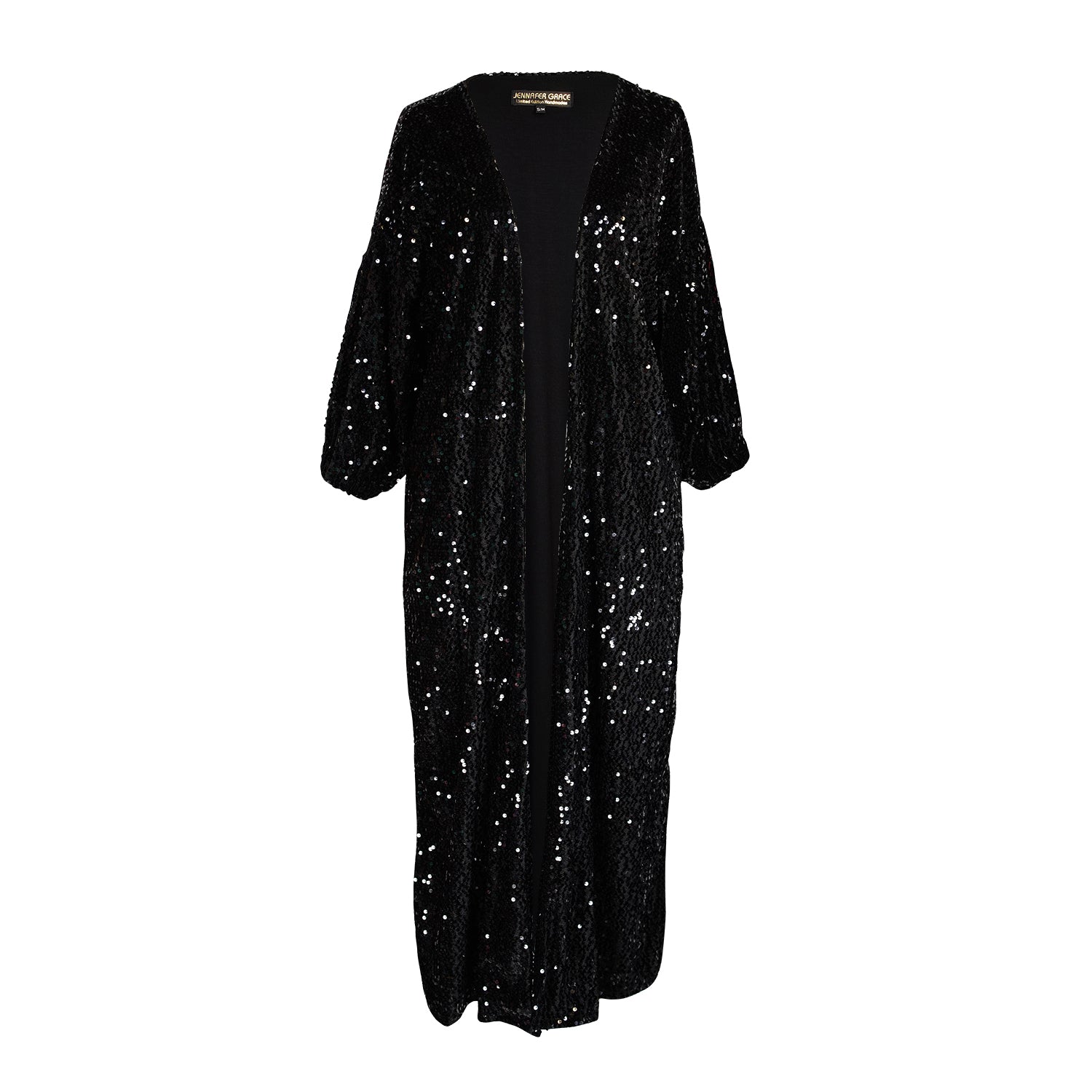 Ultra glamorous shimmering sequined cocoon jacket made from a soft black velvet inlaid with black sequins and lined with soft black jersey. Featuring cocoon sleeves and pockets with a mid-shin hem.