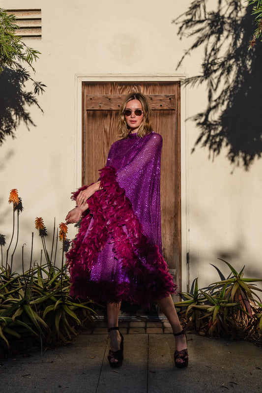 Fuchsia sequin mockneck caftan with soft plum feather border along sleeves and hem. Comes with a slip. A glamorous and sparkling, semi-sheer, stretch fabric with soft small sequins. A bohemian dress inspired by Old Hollywood glam.