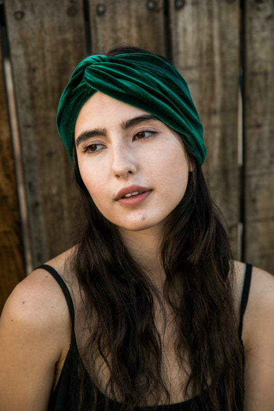 Wide, emerald green stretch velvet turban-esque fashion headband, with an elegant twist front and center. Vintage-inspired retro 1920s mixed with a modern fabric.