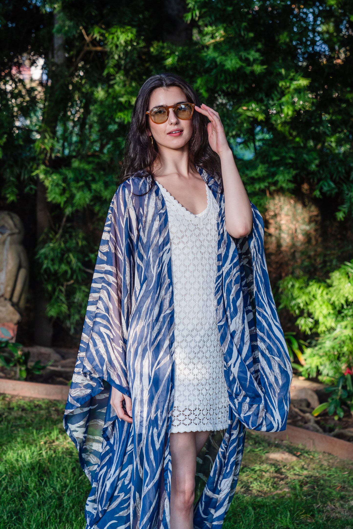  Blue zebra print kimono with belt. Can be worn open as a robe or wrap dress. Long flowy sleeves with ankle hem. Made from semi sheer rayon chiffon fabric.