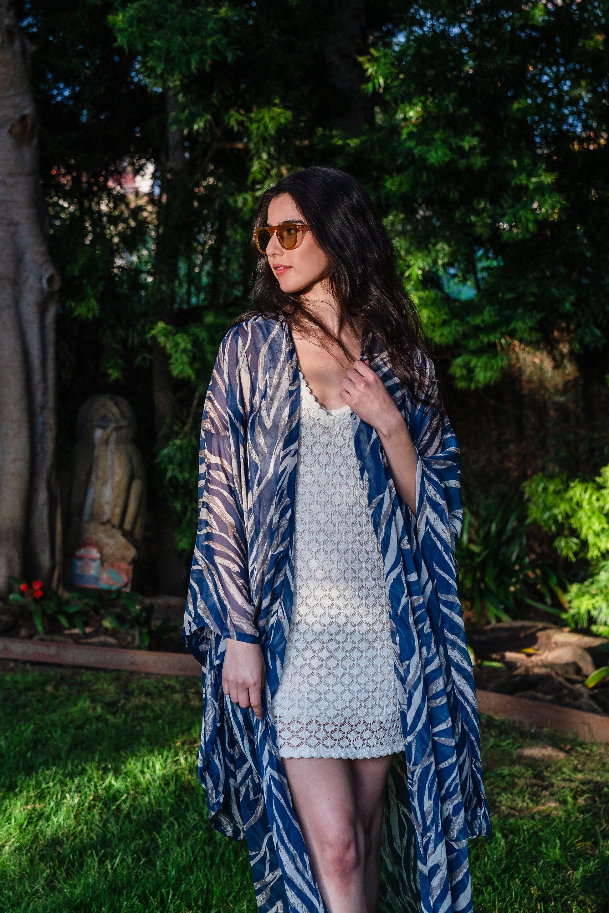  Blue zebra print kimono with belt. Can be worn open as a robe or wrap dress. Long flowy sleeves with ankle hem. Made from semi sheer rayon chiffon fabric.