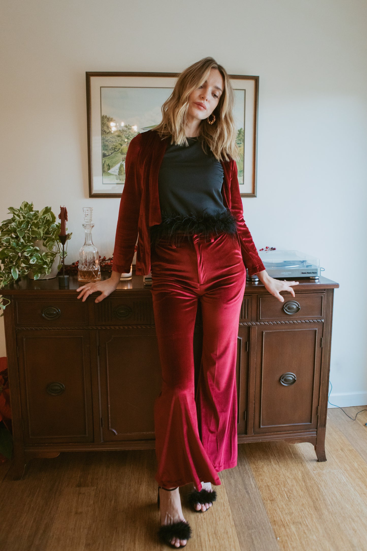 Rich oxblood red velvet bellbottom pants. Featuring a high waist and flared ends in a rich stretch velvet fabric. 