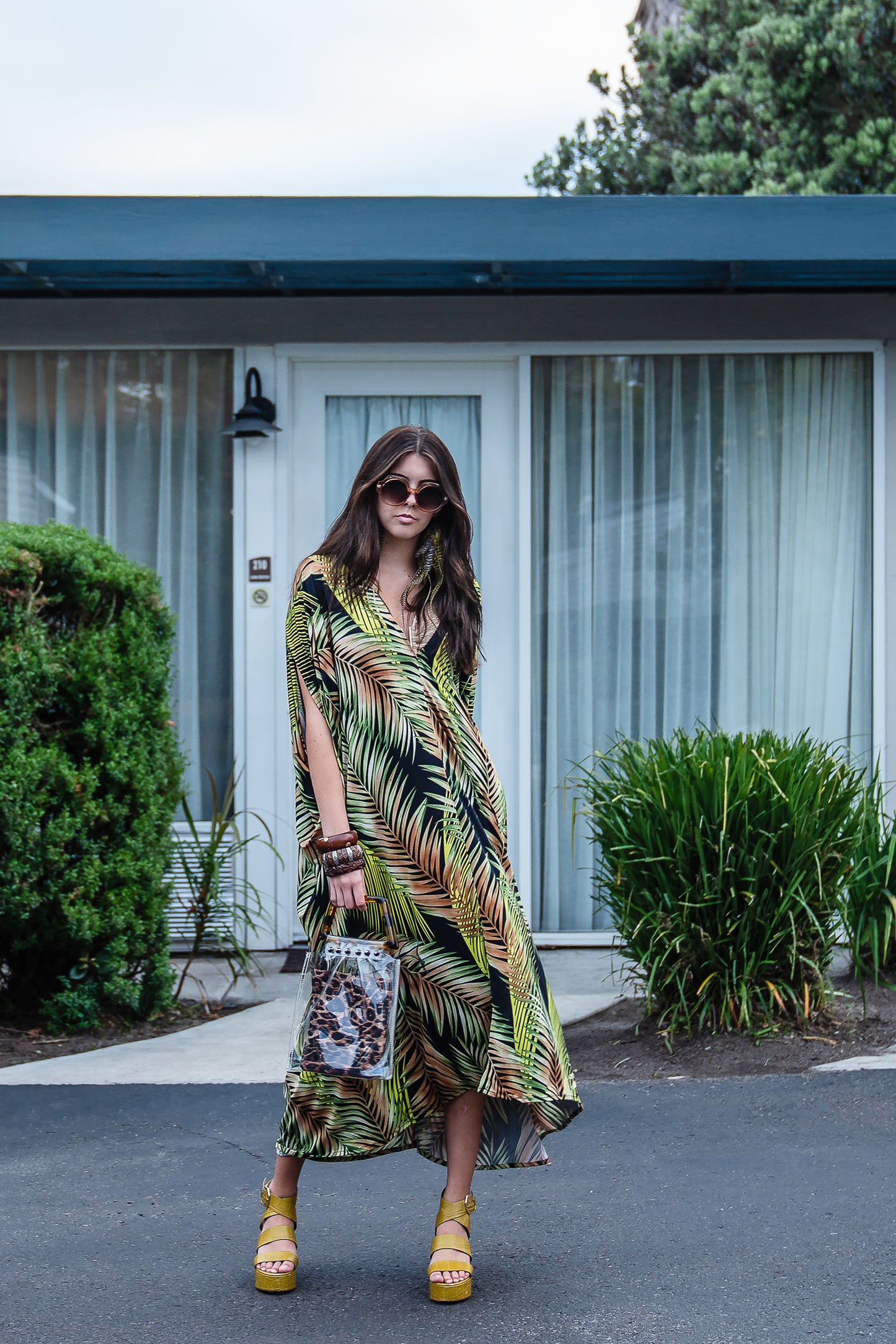 This caftan has an amazing photorealistic palm leaf print on a black background 