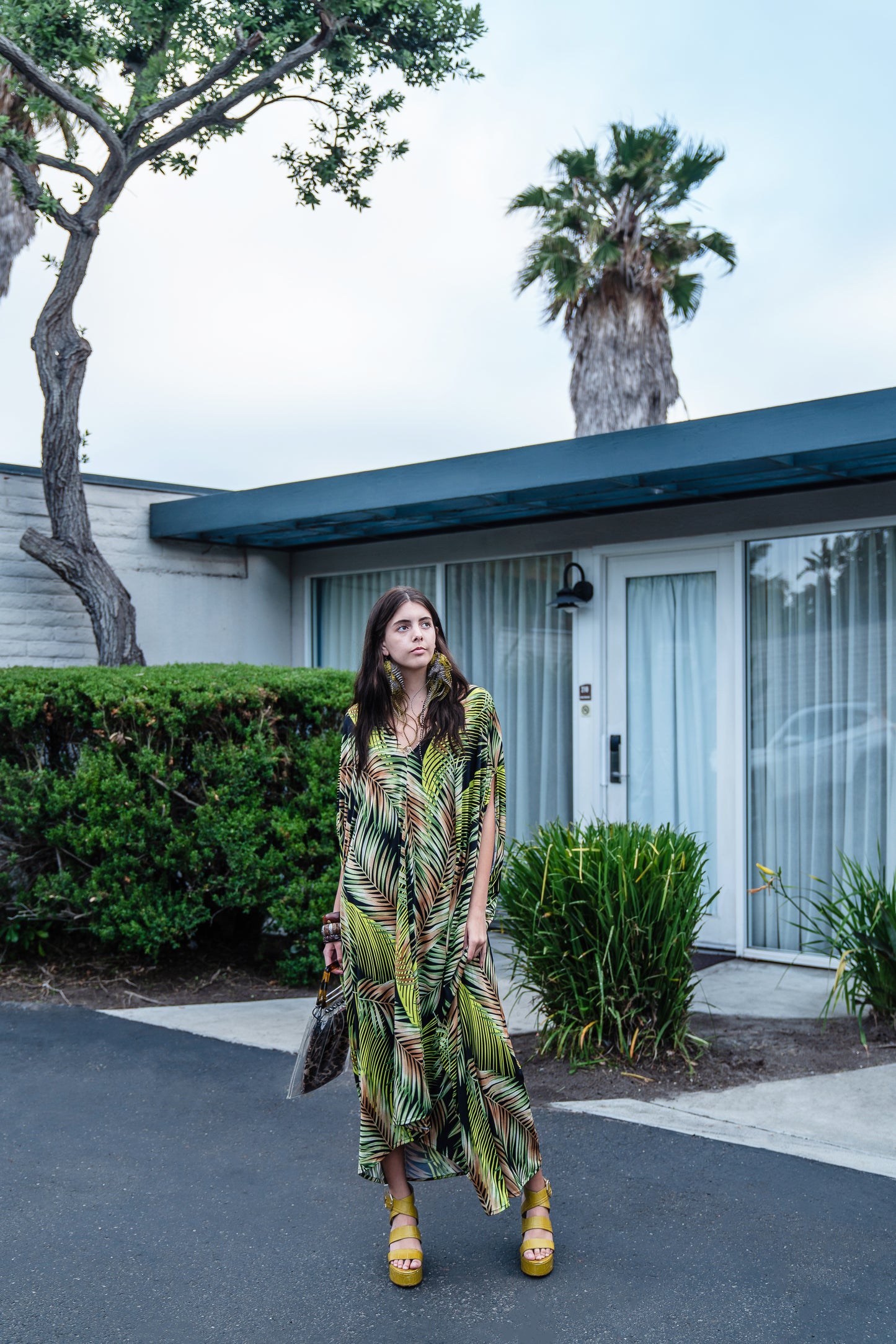 This caftan has an amazing photorealistic palm leaf print on a black background 