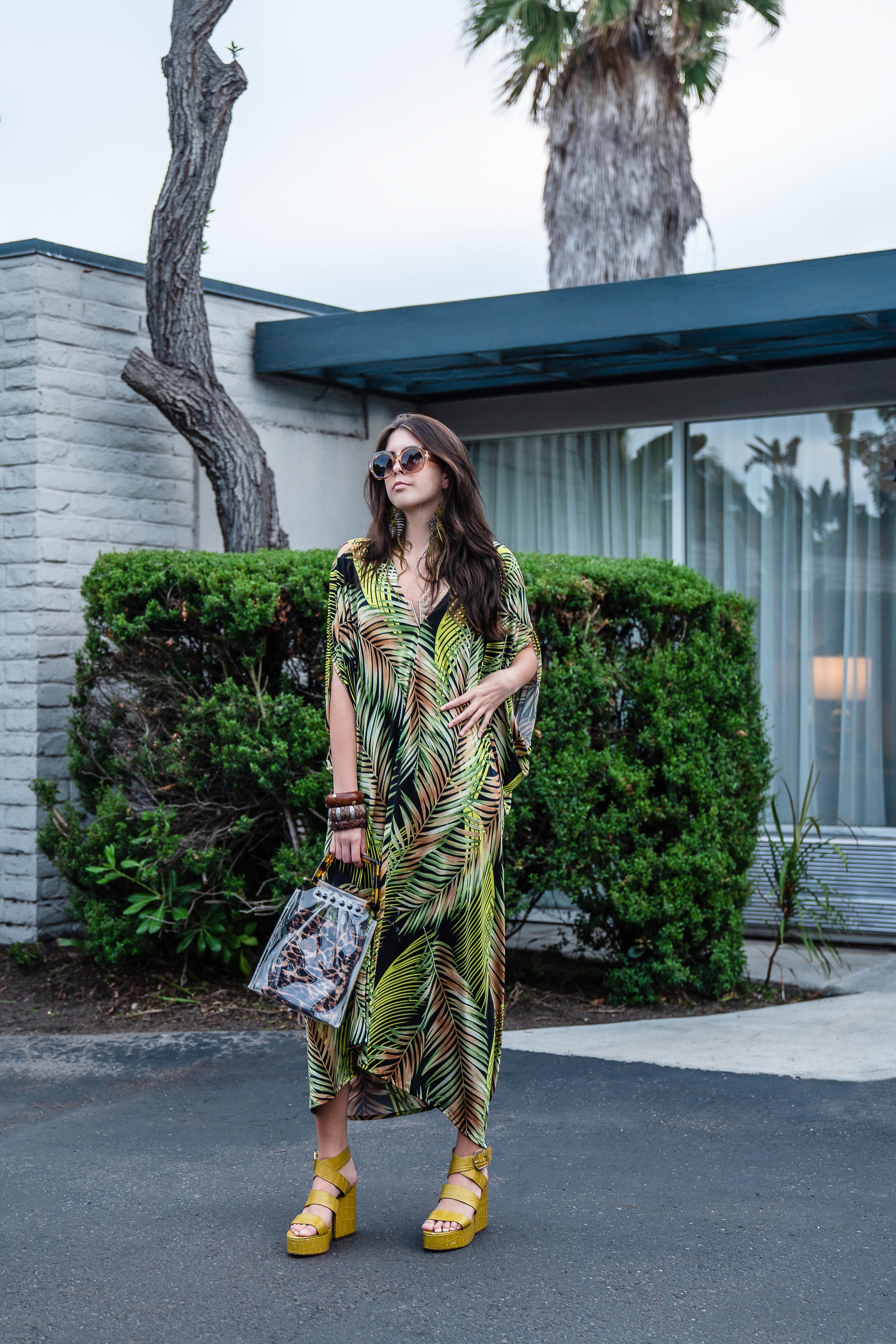 This caftan has an amazing photorealistic palm leaf print on a black background 