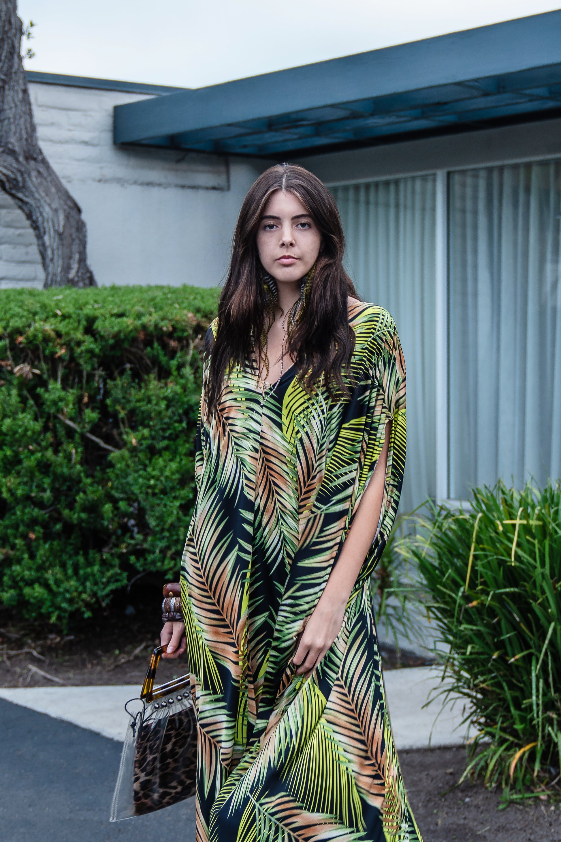 This caftan has an amazing photorealistic palm leaf print on a black background 