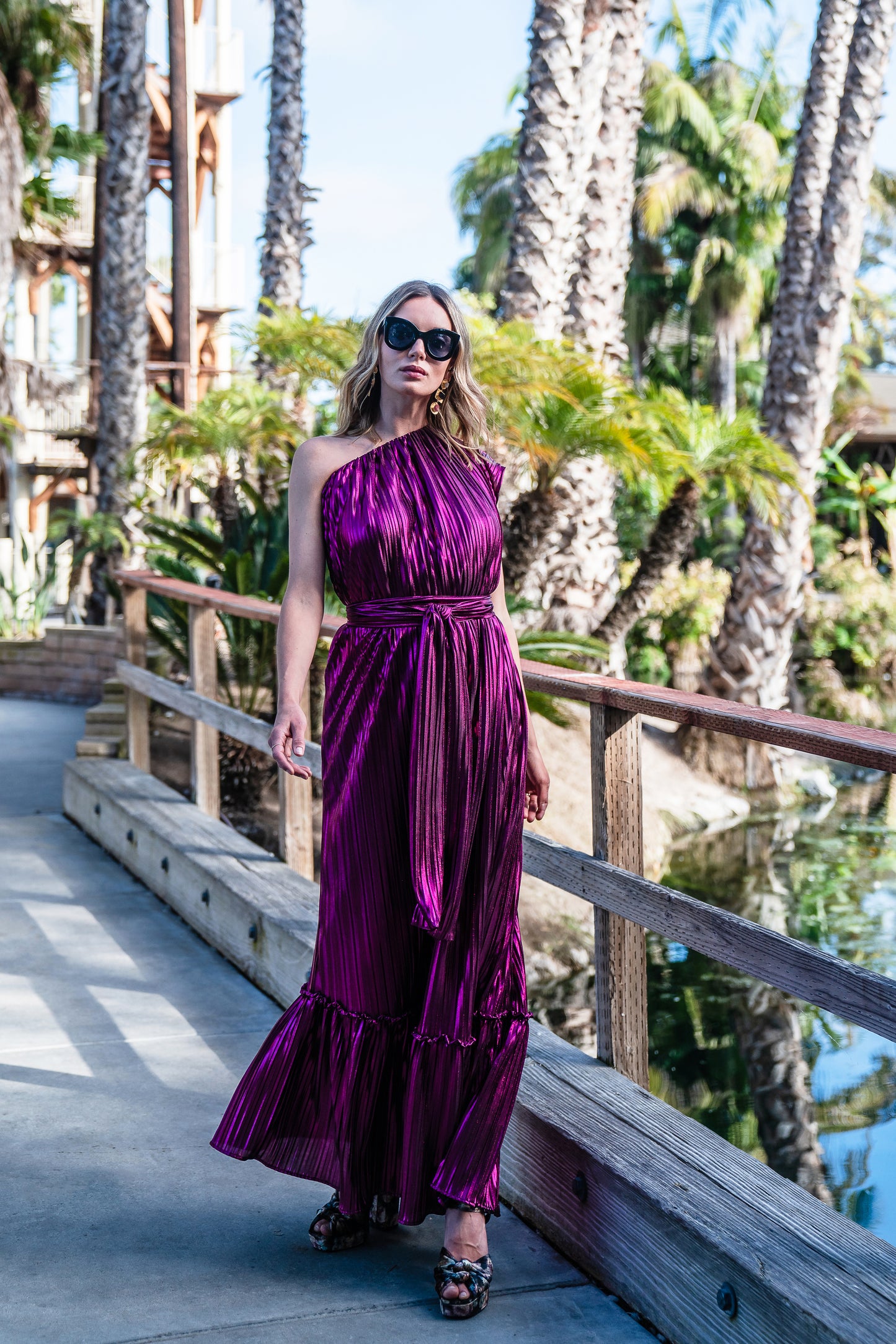 Effortlessly elegant, the Midnight Bubblegum Pleated Maxi Dress features a flattering one shoulder design and an eye-catching ink shimmer pleated fabric.