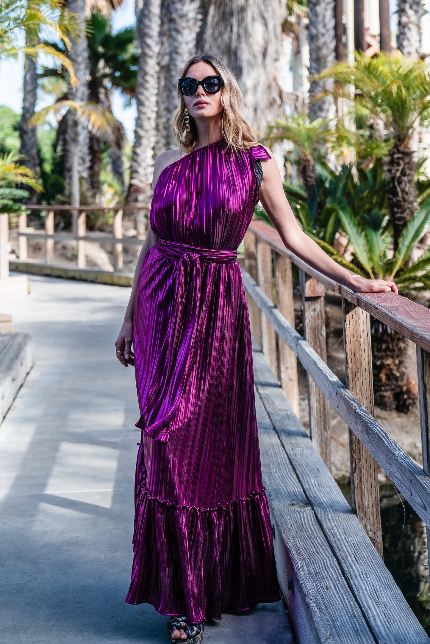 Effortlessly elegant, the Midnight Bubblegum Pleated Maxi Dress features a flattering one shoulder design and an eye-catching ink shimmer pleated fabric.