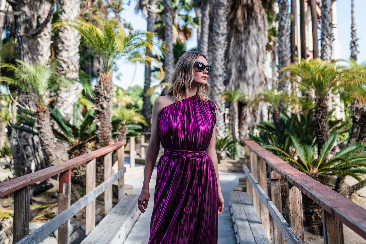 Effortlessly elegant, the Midnight Bubblegum Pleated Maxi Dress features a flattering one shoulder design and an eye-catching ink shimmer pleated fabric.