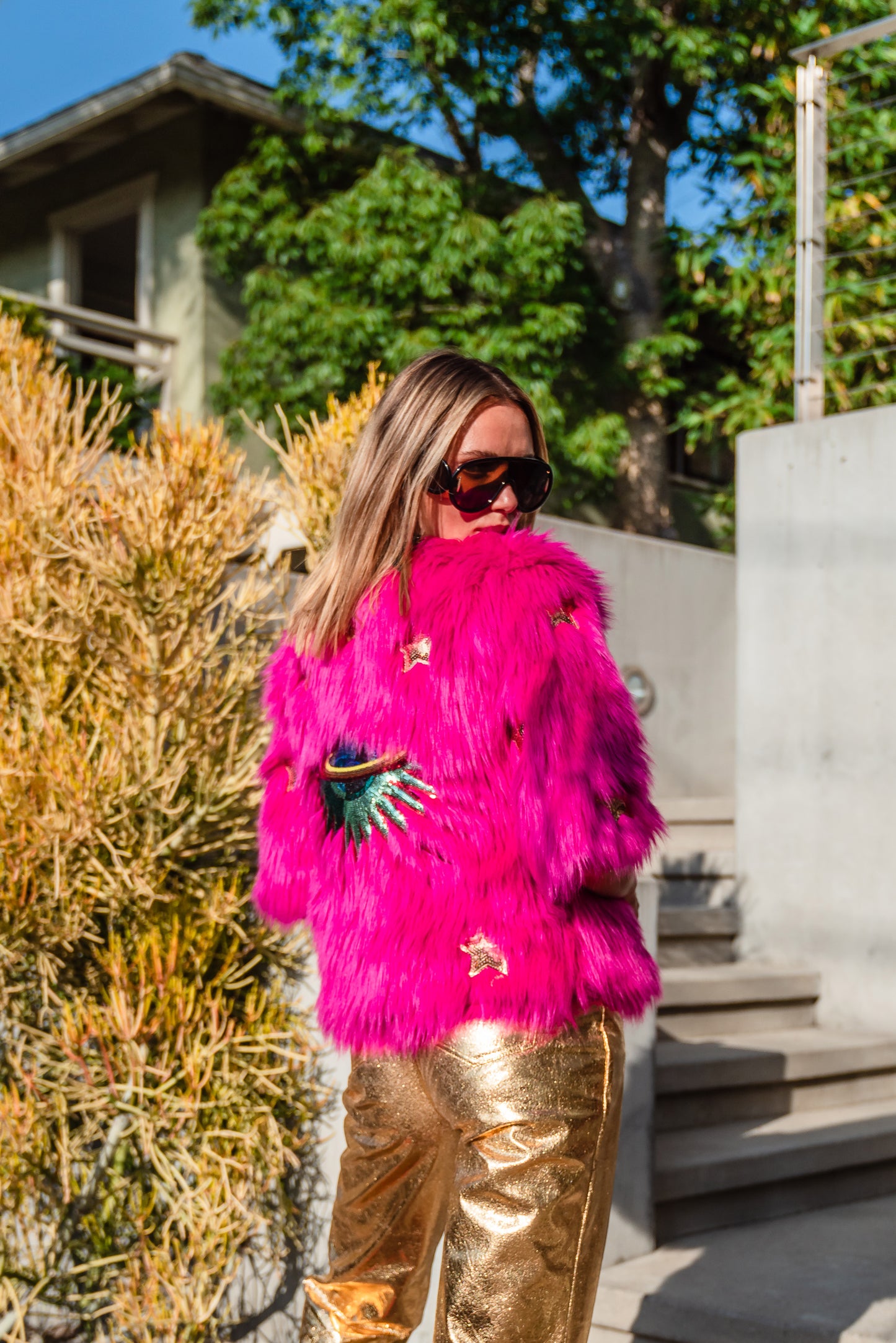 The out-of-this-world Planet Queen jacket is hand crafted with stunning sequin UFO and gold star patches on ultra soft synthetic neon pink all faux fur. Featuring pockets and a bright, cheerful rayon lining, this jacket is hip length with a forearm hem.