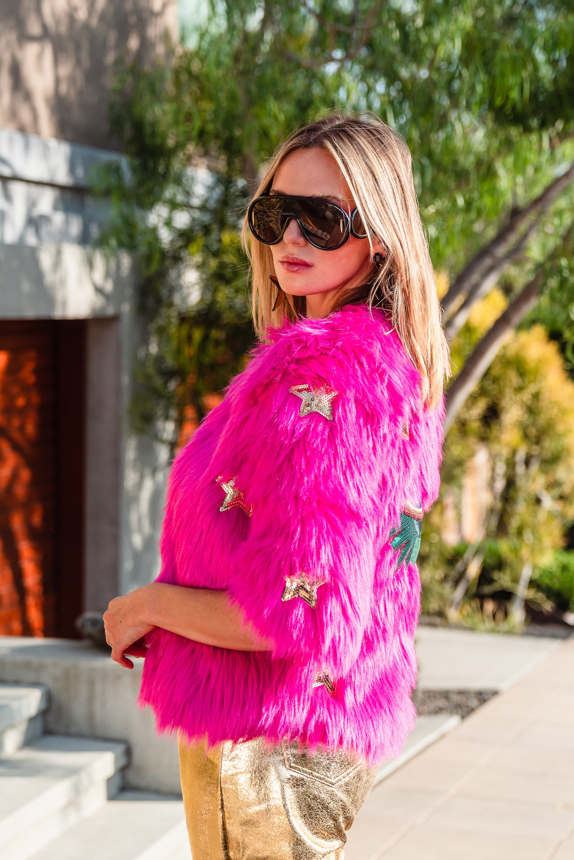 The out-of-this-world Planet Queen jacket is hand crafted with stunning sequin UFO and gold star patches on ultra soft synthetic neon pink all faux fur. Featuring pockets and a bright, cheerful rayon lining, this jacket is hip length with a forearm hem.