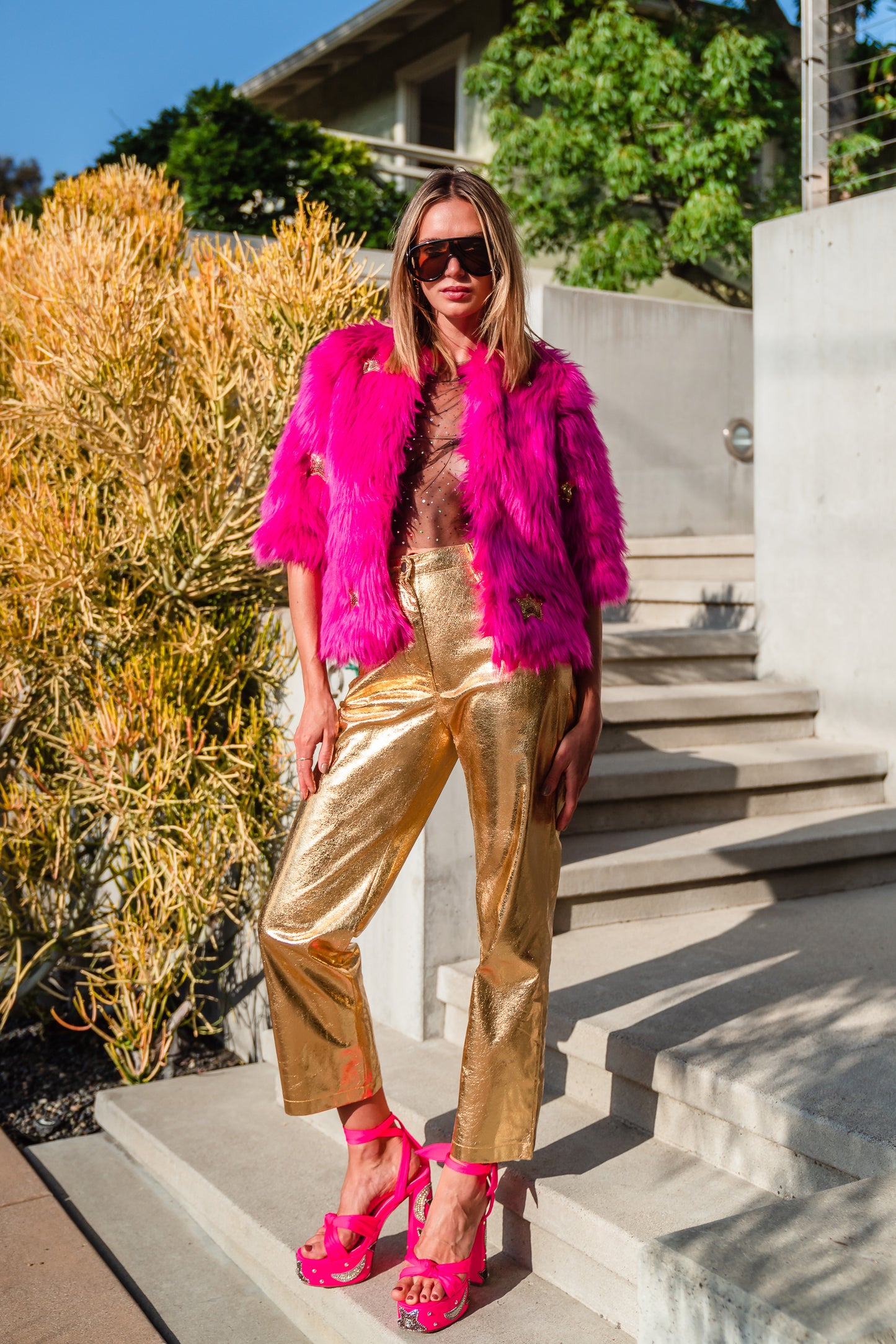 The out-of-this-world Planet Queen jacket is hand crafted with stunning sequin UFO and gold star patches on ultra soft synthetic neon pink all faux fur. Featuring pockets and a bright, cheerful rayon lining, this jacket is hip length with a forearm hem.