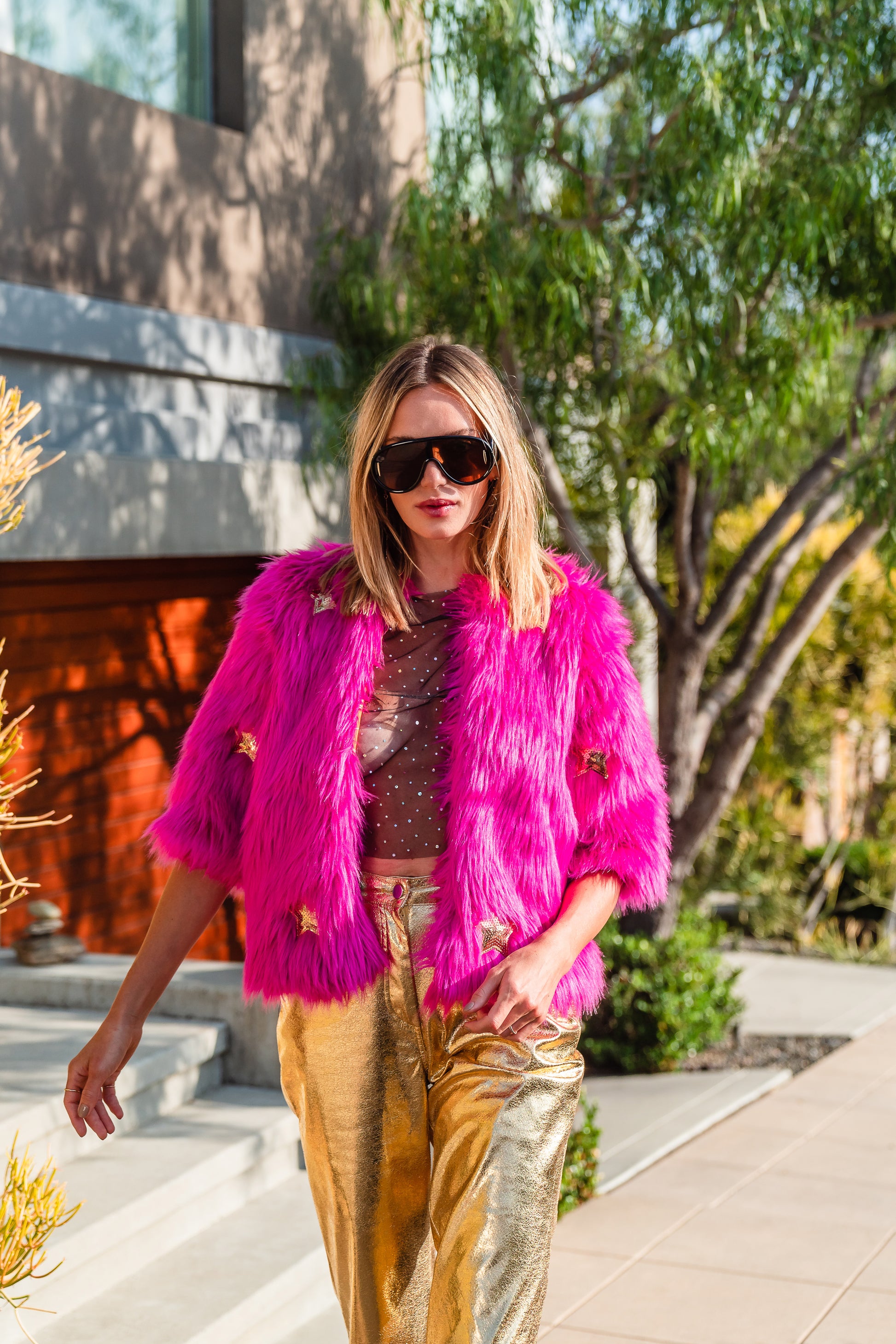 The out-of-this-world Planet Queen jacket is hand crafted with stunning sequin UFO and gold star patches on ultra soft synthetic neon pink all faux fur. Featuring pockets and a bright, cheerful rayon lining, this jacket is hip length with a forearm hem.