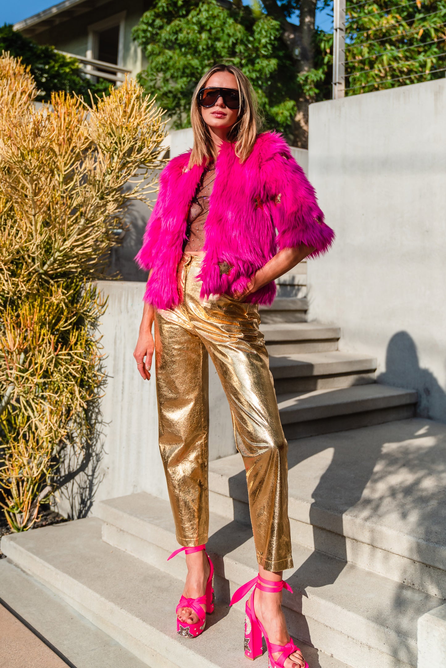 The out-of-this-world Planet Queen jacket is hand crafted with stunning sequin UFO and gold star patches on ultra soft synthetic neon pink all faux fur. Featuring pockets and a bright, cheerful rayon lining, this jacket is hip length with a forearm hem.