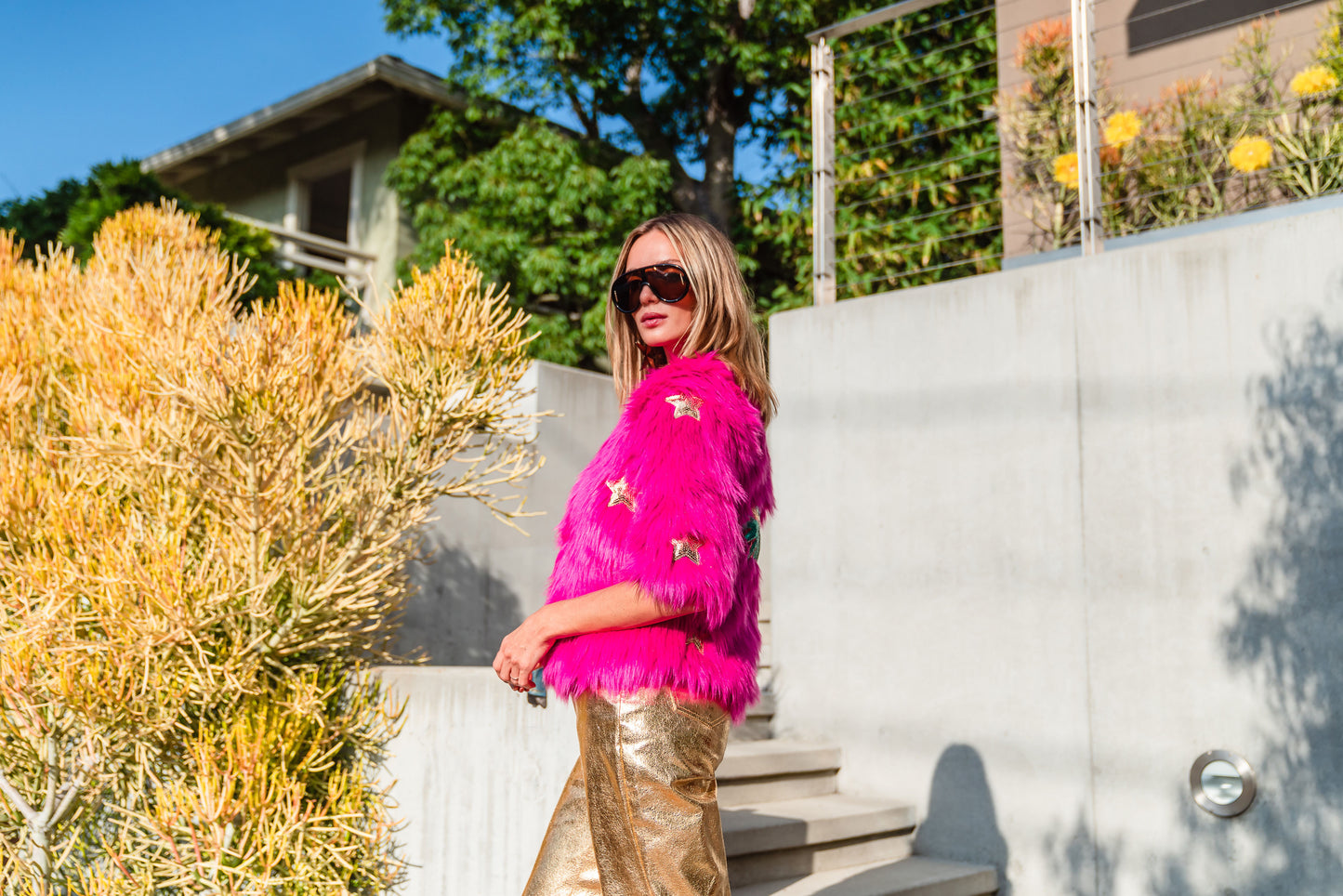 The out-of-this-world Planet Queen jacket is hand crafted with stunning sequin UFO and gold star patches on ultra soft synthetic neon pink all faux fur. Featuring pockets and a bright, cheerful rayon lining, this jacket is hip length with a forearm hem.