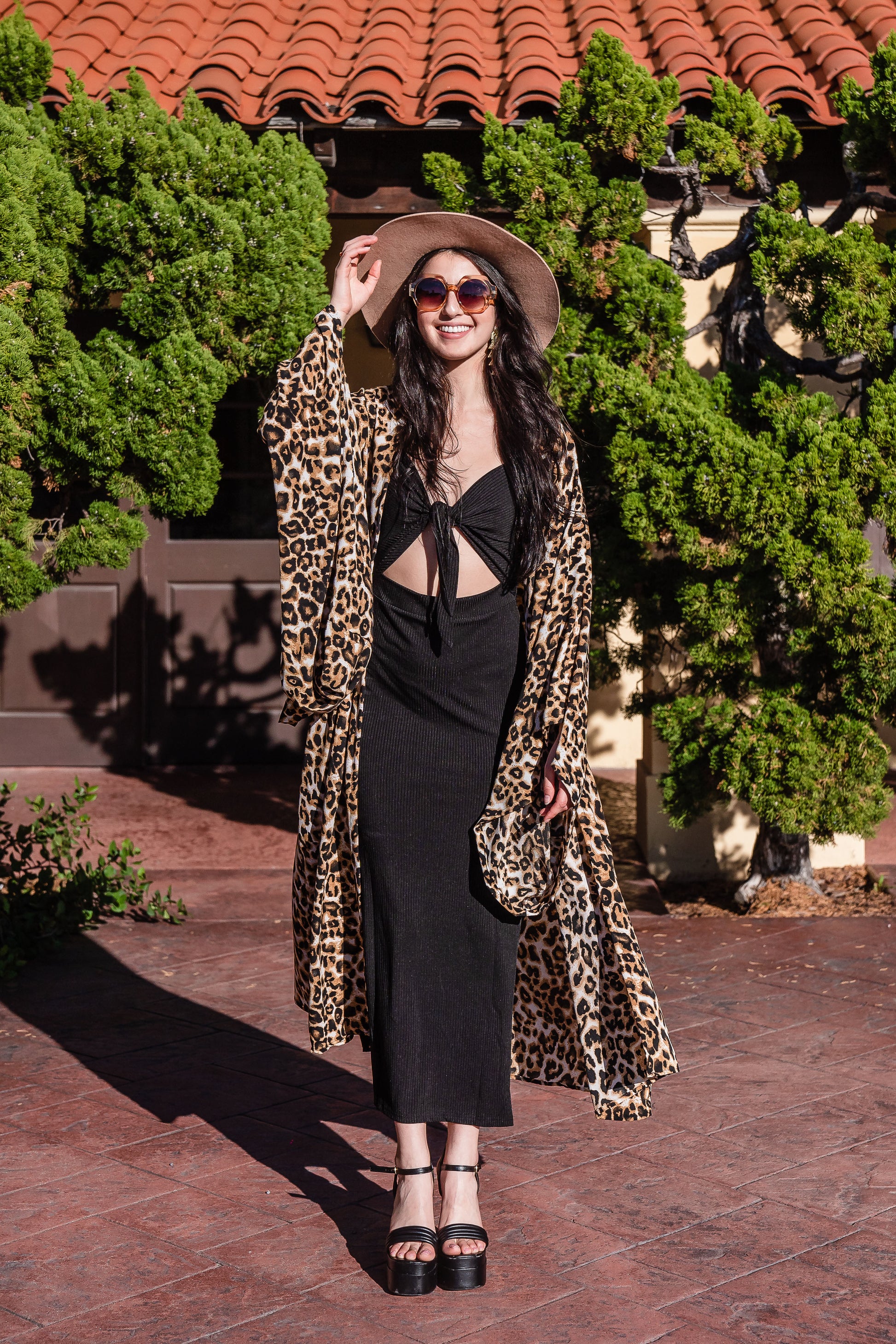 Leopard print fashion kimono robe featuring shades of brown, white, and black. It has a wrap tie waist for a cinched look, v-neck, square sleeves, and an ankle length hem. Classic, bohemian retro aesthetic.