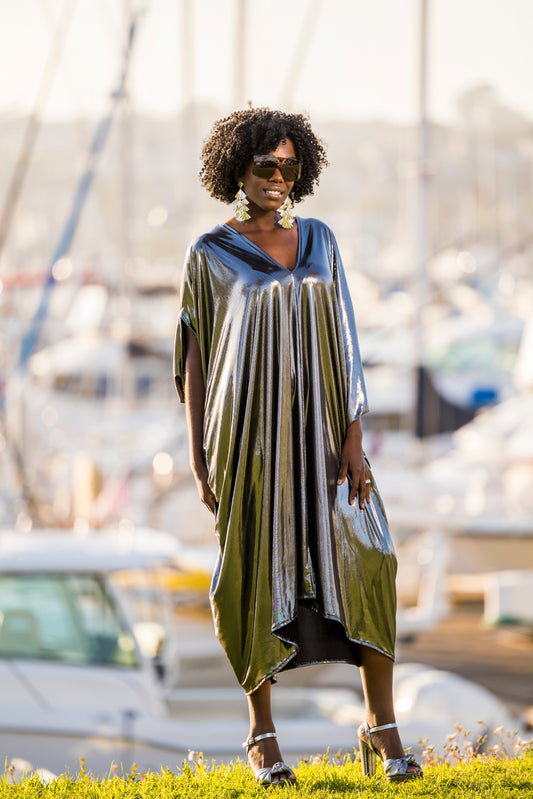 Silver metallic caftan featuring a deep v-neckline, batwing sleeves, and ankle length hem. 