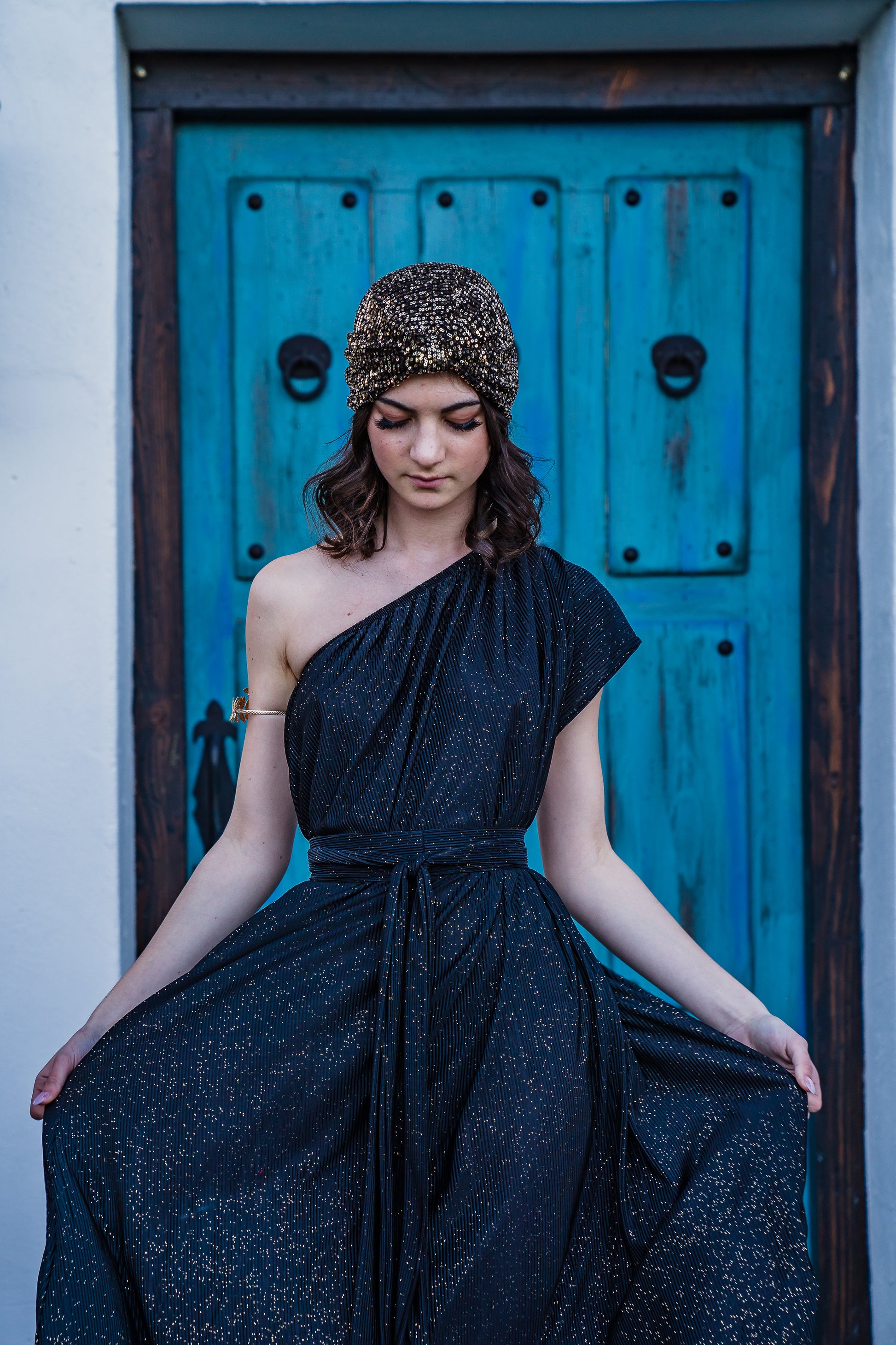 This one shoulder maxi dress was made with luxurious pleated glittery fabric.