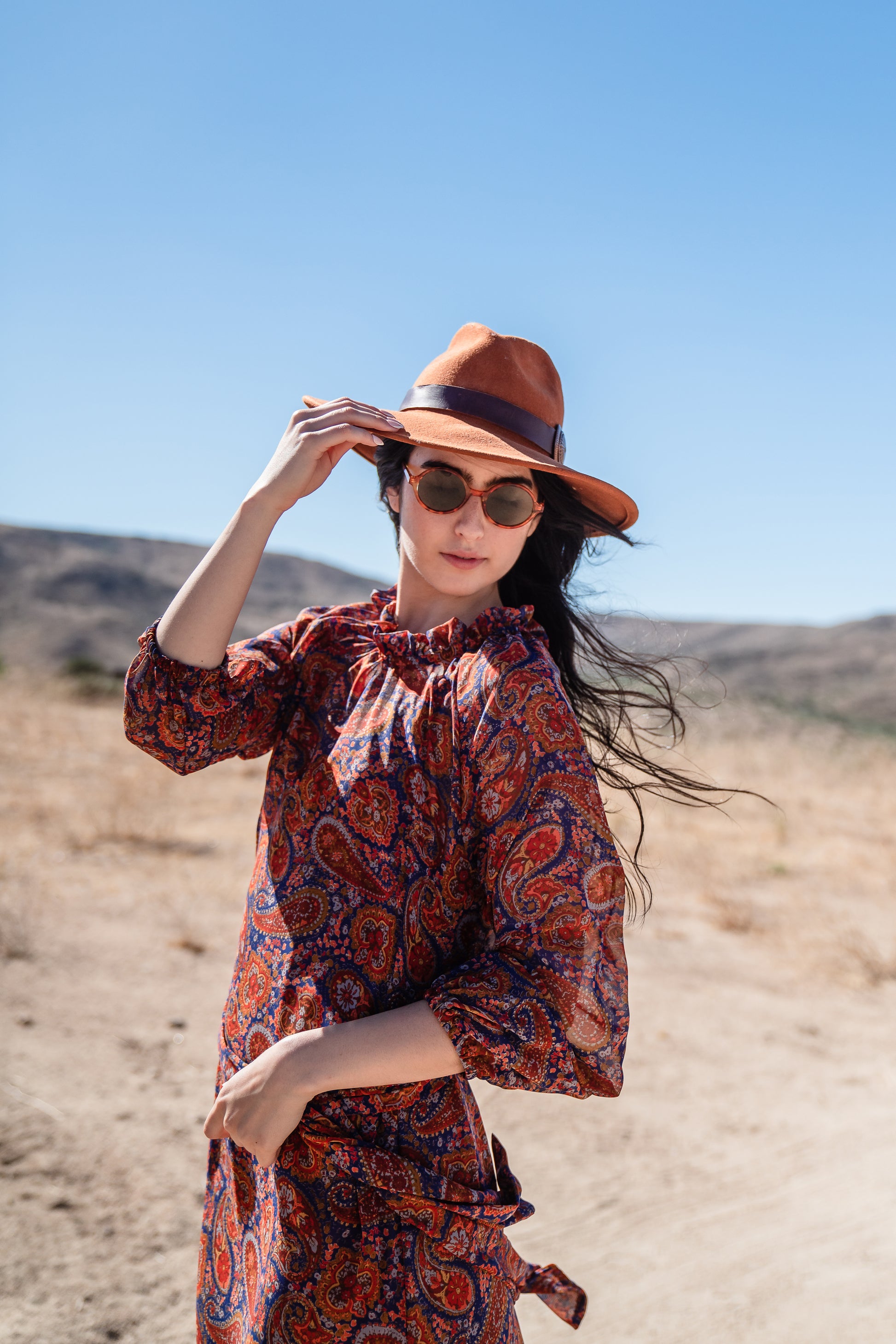 This ruffle collar, Paisley print, boho maxi dress features a soft cross ruffle skirt, blouson sleeve and hook and eye at back.