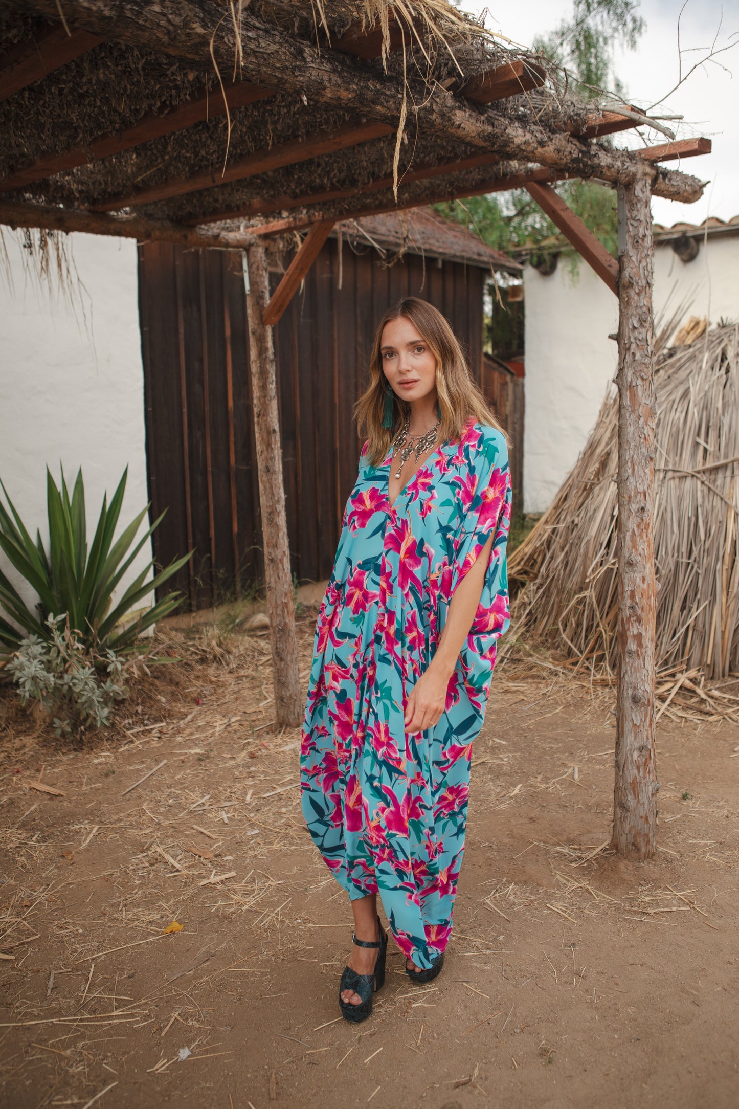 Light aqua blue caftan with fuchsia hot pink floral stargazer lily print and dark green leaves, vibrant colorful kaftan with deep v and short batwing sleeves, bohemian style