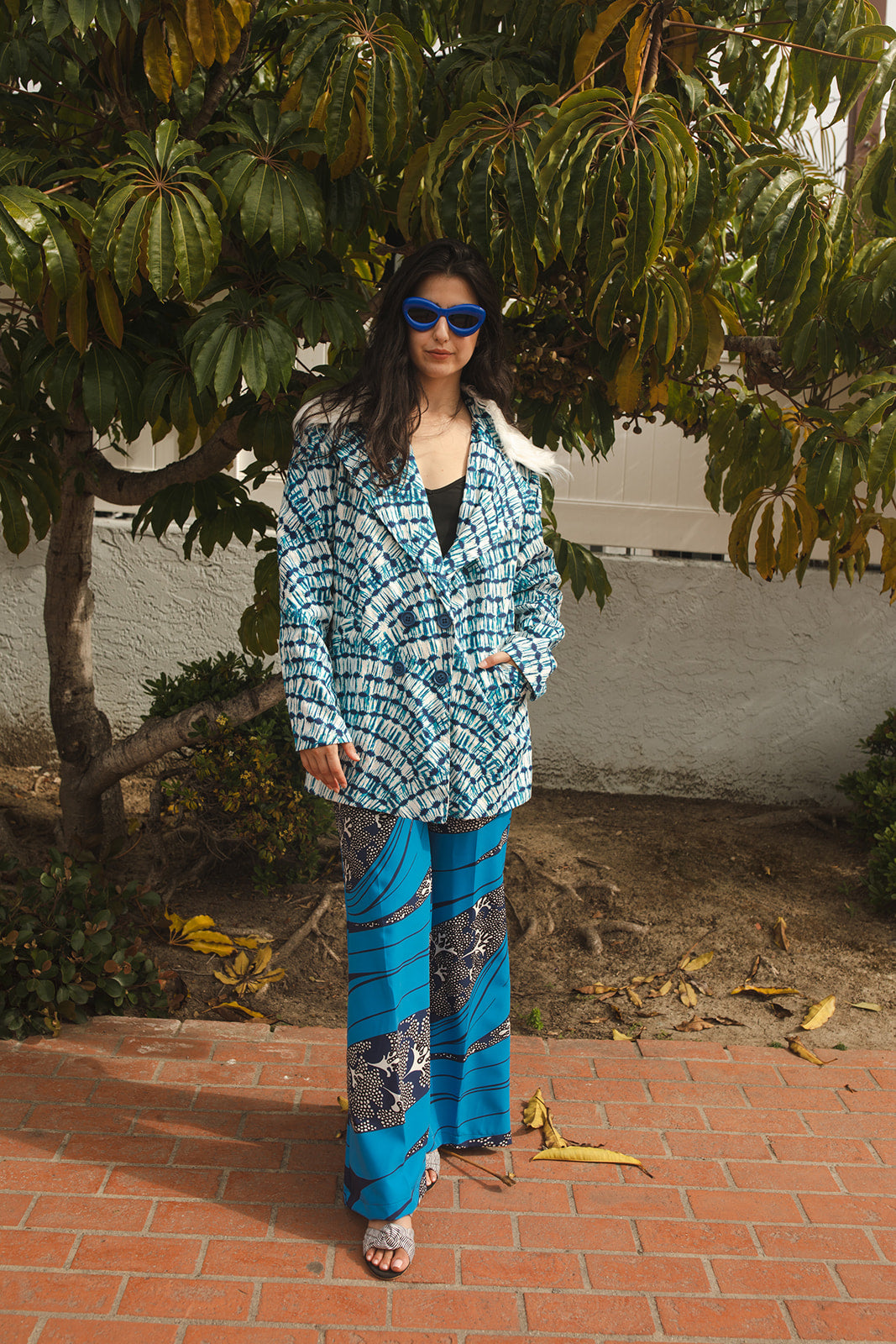 Boasting a striking aquarian color scheme on hand printed african fabric, this stylish piece is lined with a lush blue jersey and features a removable faux fur collar. 