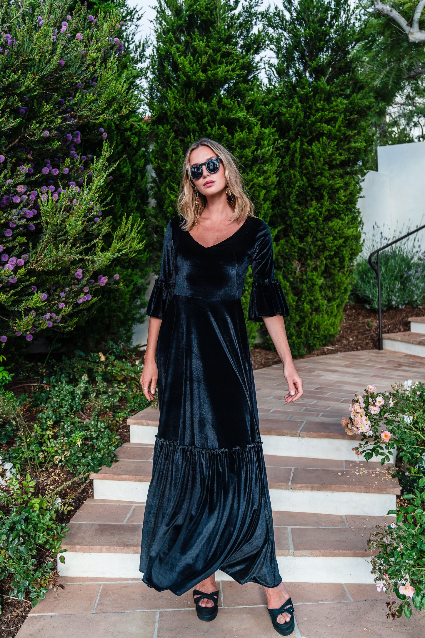 Shimmery black maxi dress with ruffle skirt and ruffled half sleeves. Featuring v-neck frontn and heart-shaped cutout in back, this dark dress is a gothic dream.