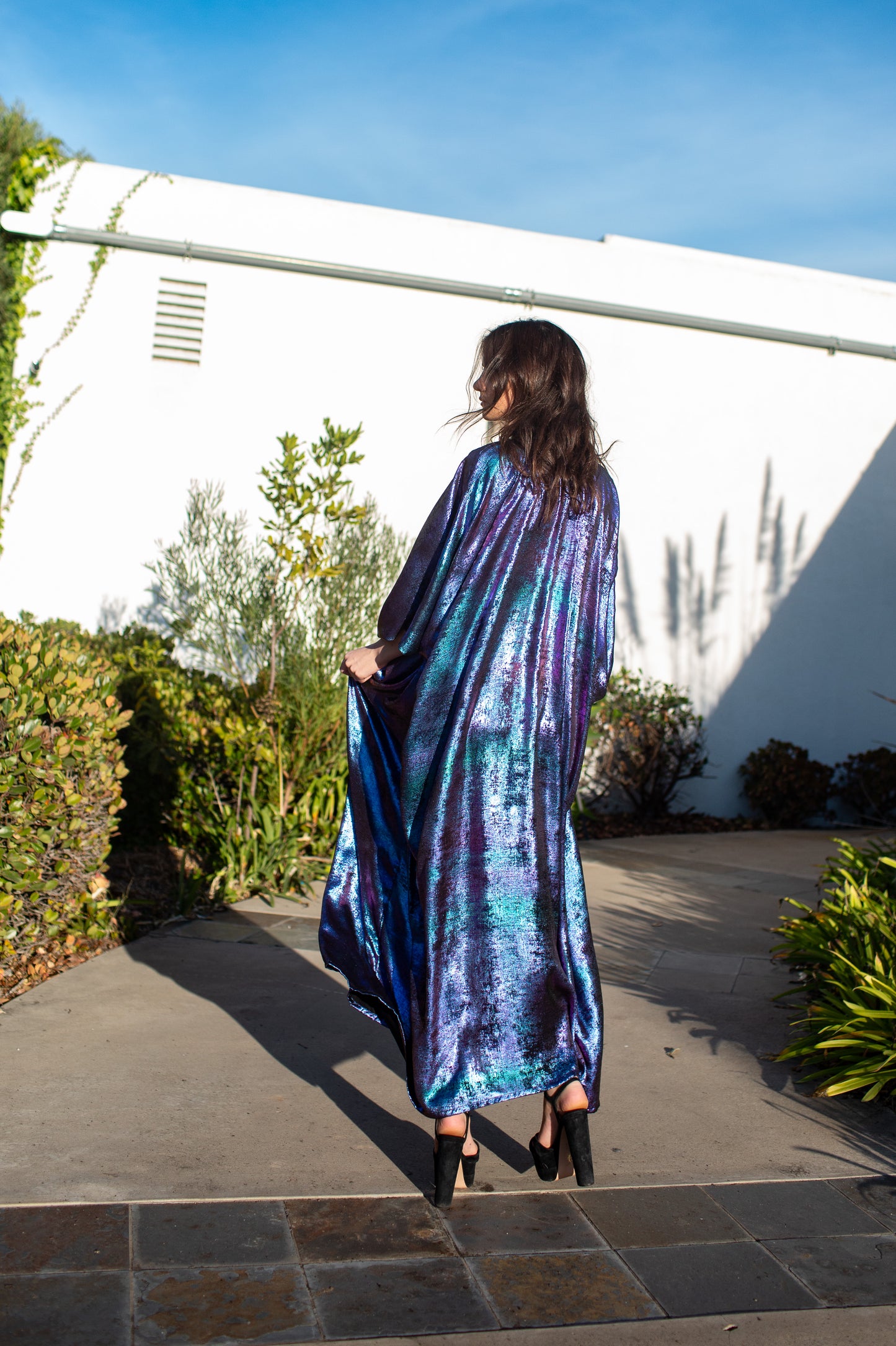 A shimmering Micro Velvet in rich amethyst tones. This new shape includes an attached waist tie to add new ways of wearing our classic caftan shape.