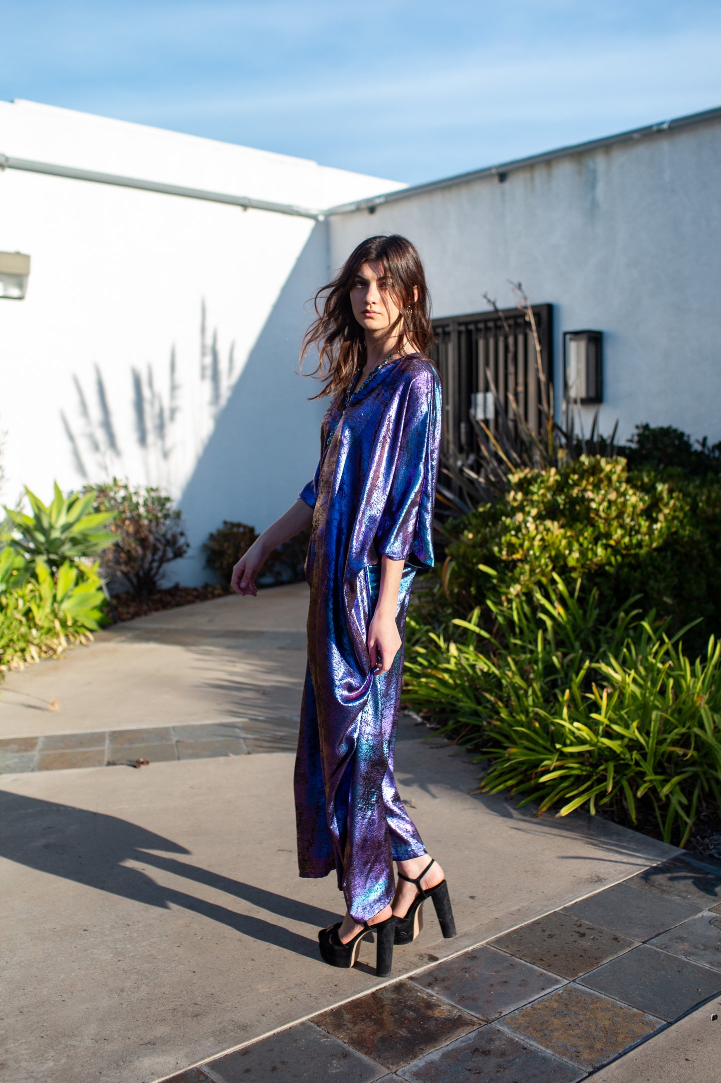 A shimmering Micro Velvet in rich amethyst tones. This new shape includes an attached waist tie to add new ways of wearing our classic caftan shape.