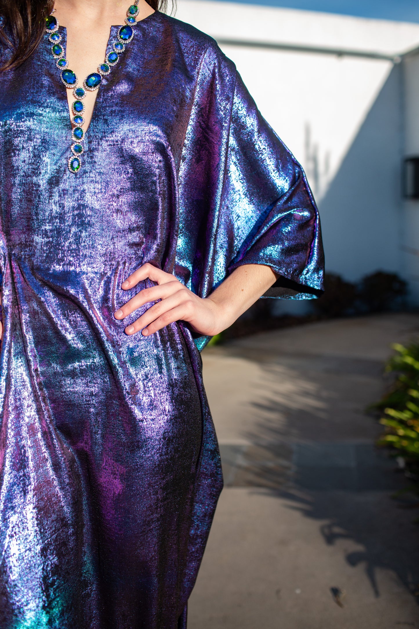 A shimmering Micro Velvet in rich amethyst tones. This new shape includes an attached waist tie to add new ways of wearing our classic caftan shape.