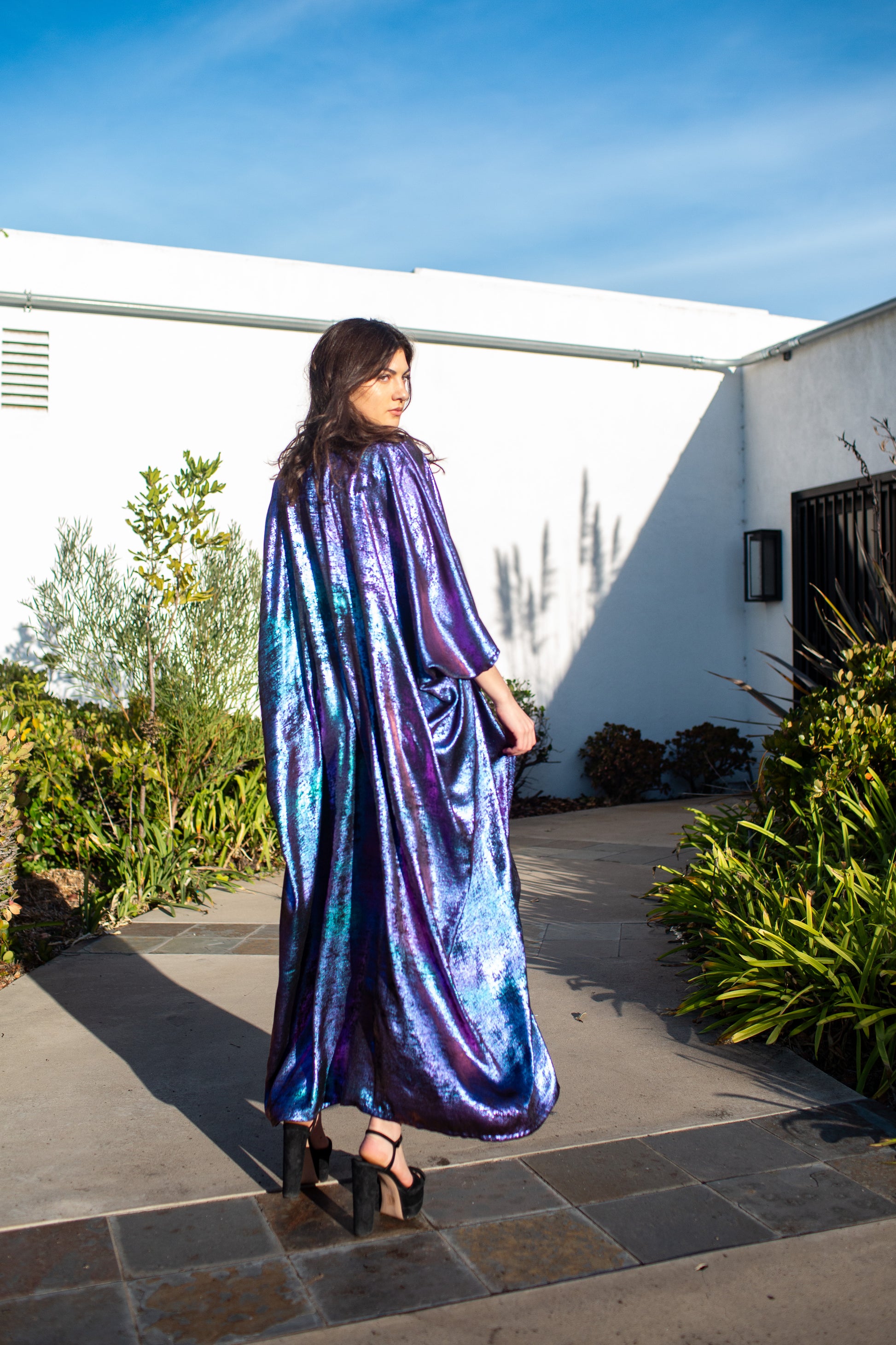 A shimmering Micro Velvet in rich amethyst tones. This new shape includes an attached waist tie to add new ways of wearing our classic caftan shape.