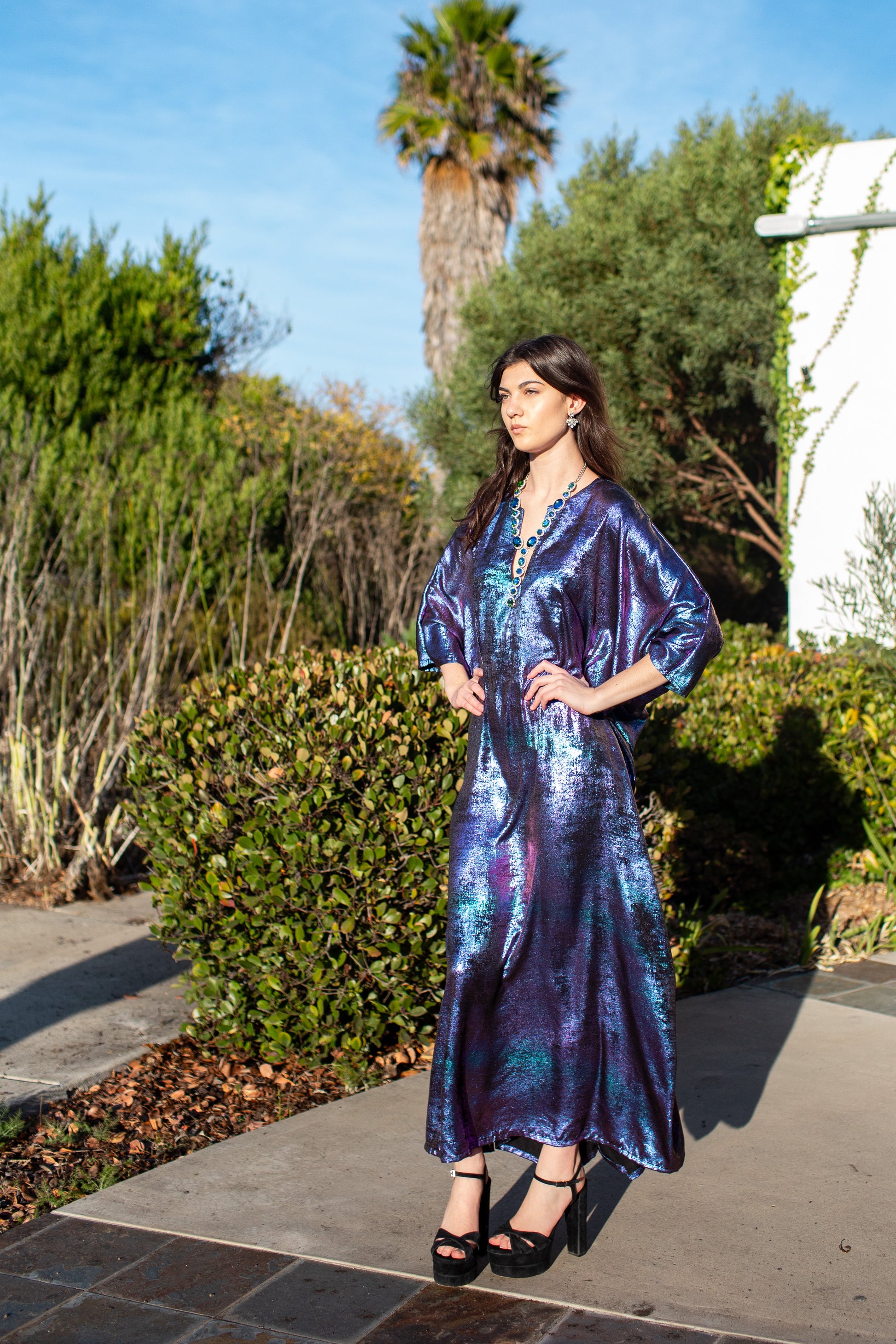 A shimmering Micro Velvet in rich amethyst tones. This new shape includes an attached waist tie to add new ways of wearing our classic caftan shape.