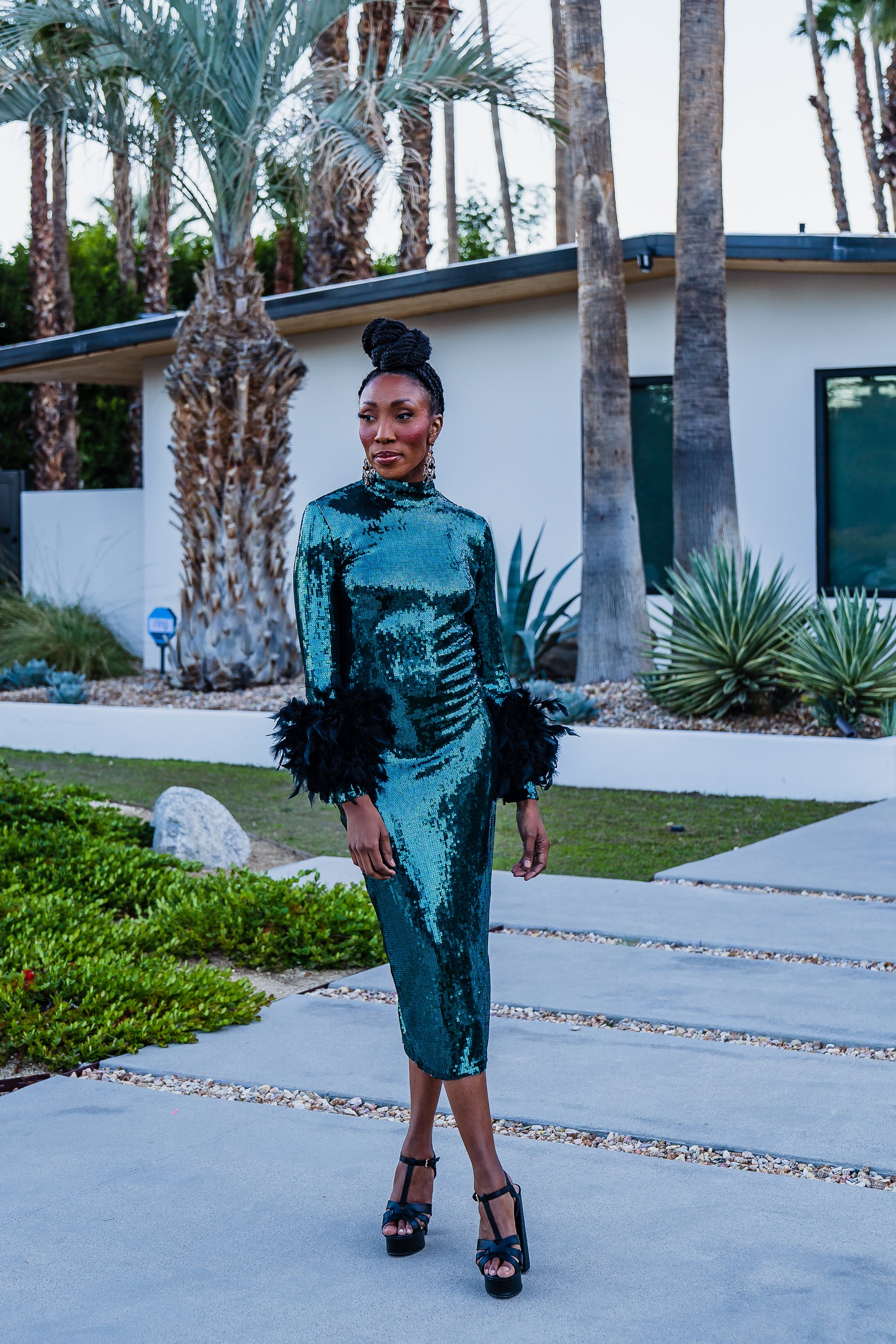 The emerald sequined, bodycon design accentuates your curves, while the removable feather trim on the sleeves adds a touch of elegance.