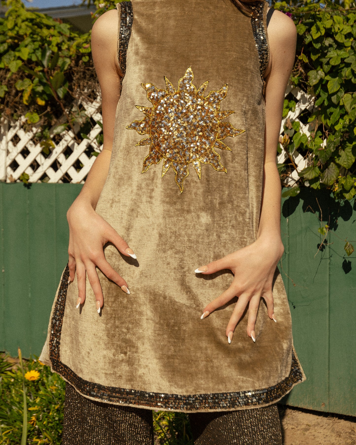 This exquisite velvet tunic is a vintage-inspired piece that combines the epic romance of the medieval with the bold search for expression that is midcentury. Featuring an intricate sequined Sun and shimmering sequin mesh appliqued to true velvet fabric, this fearless silhouette will stand the test of time in any wardrobe.