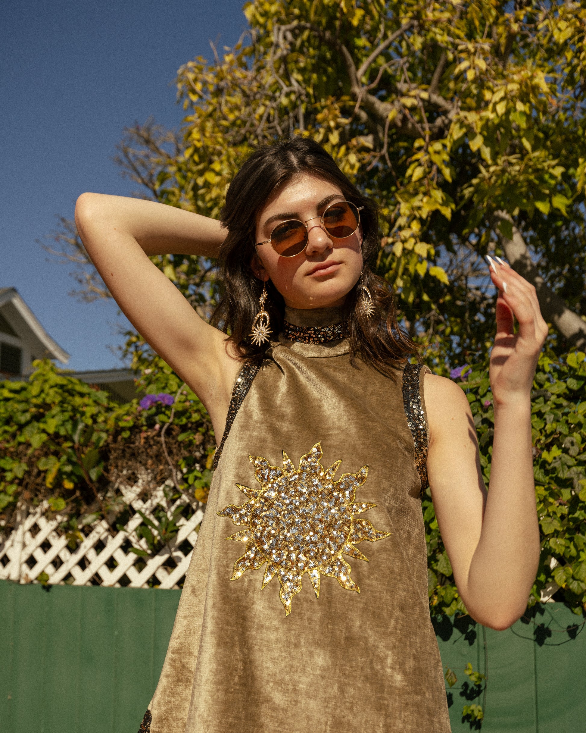 This exquisite velvet tunic is a vintage-inspired piece that combines the epic romance of the medieval with the bold search for expression that is midcentury. Featuring an intricate sequined Sun and shimmering sequin mesh appliqued to true velvet fabric, this fearless silhouette will stand the test of time in any wardrobe.