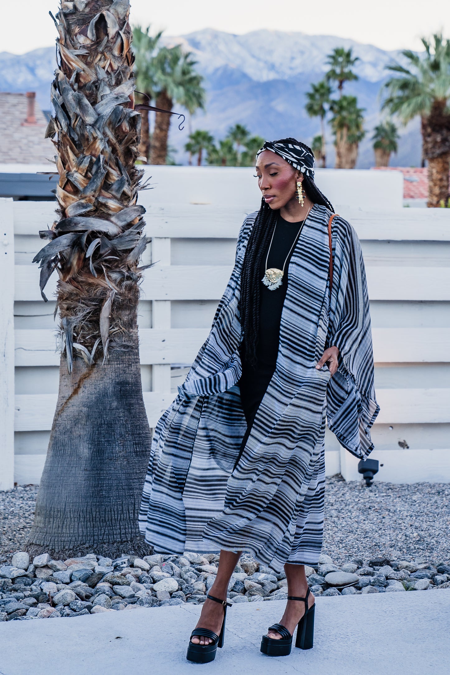 This iconic kimono was handmade in San Diego, CA with a black and white zigzag stripe patterned chiffon. Featuring pockets and a matching waist tie